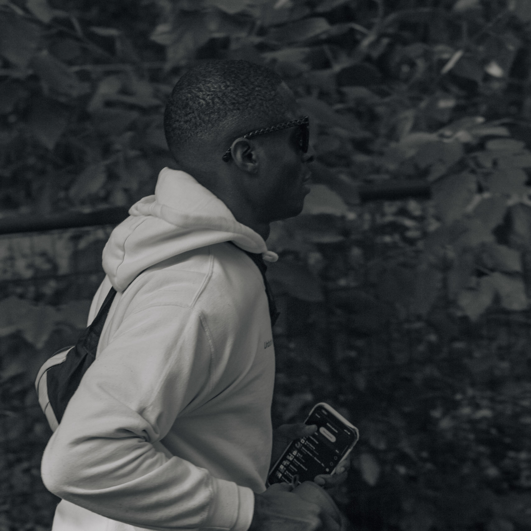 Black Men Run NYC club member, holds his speaker as he runs to catch back up with the group during the club's weekly sunday run in Prospect Park in Brooklyn, Sunday, Oct. 15, 2023, Photo Tabius McCoy