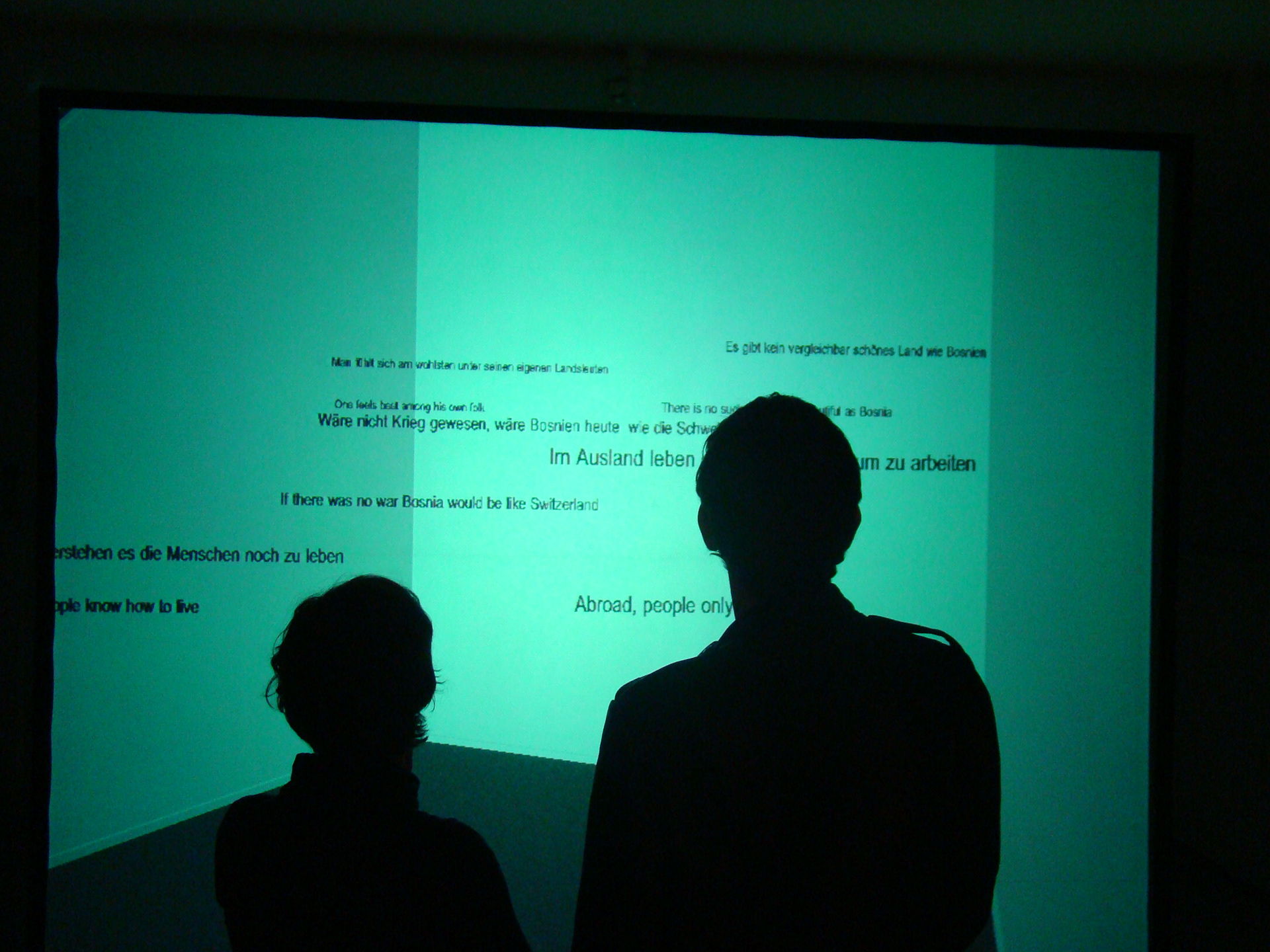 Exhibition viewers reading the floating 3D quotes