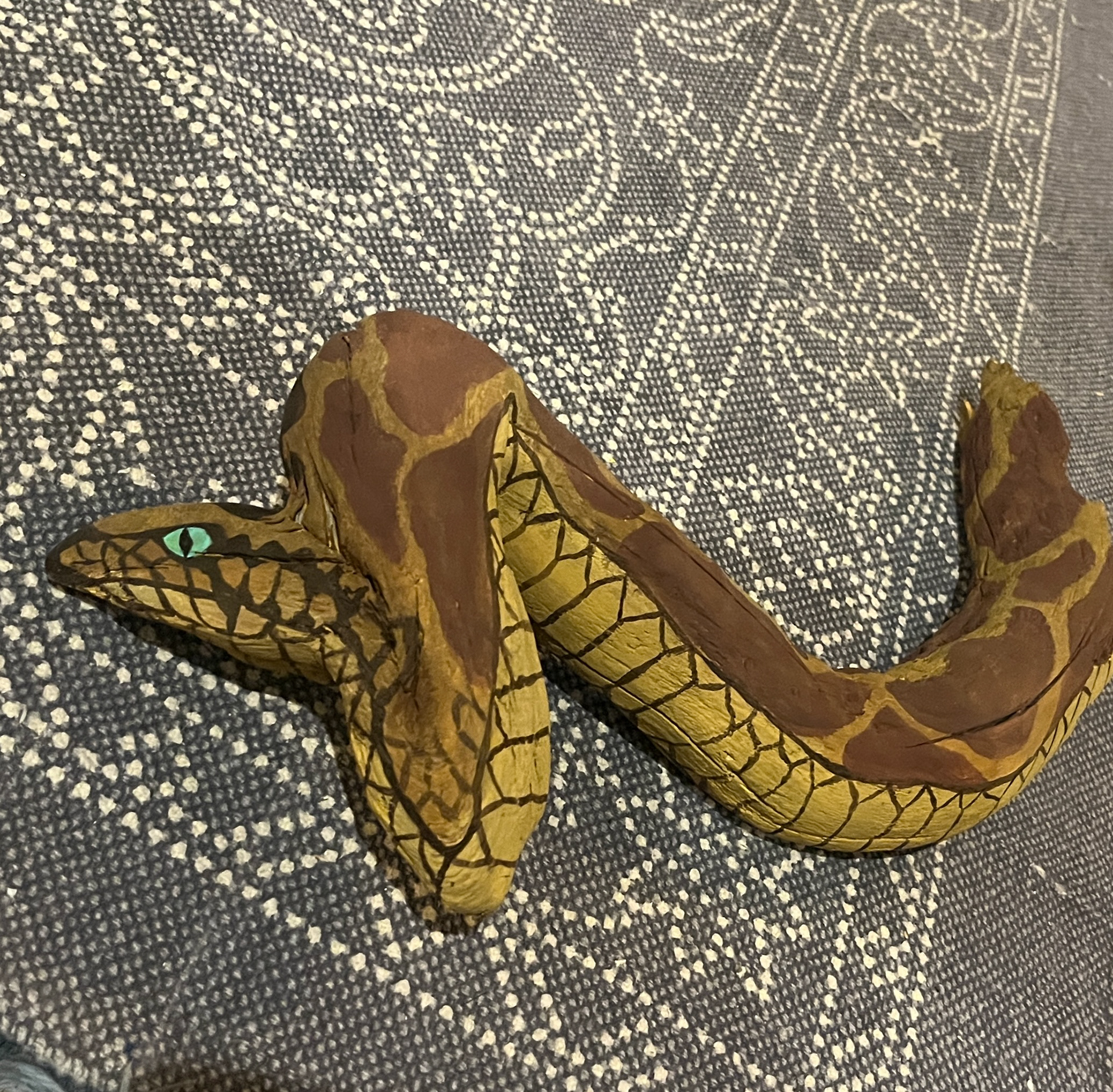 A piece of driftwood painted as a snake. 