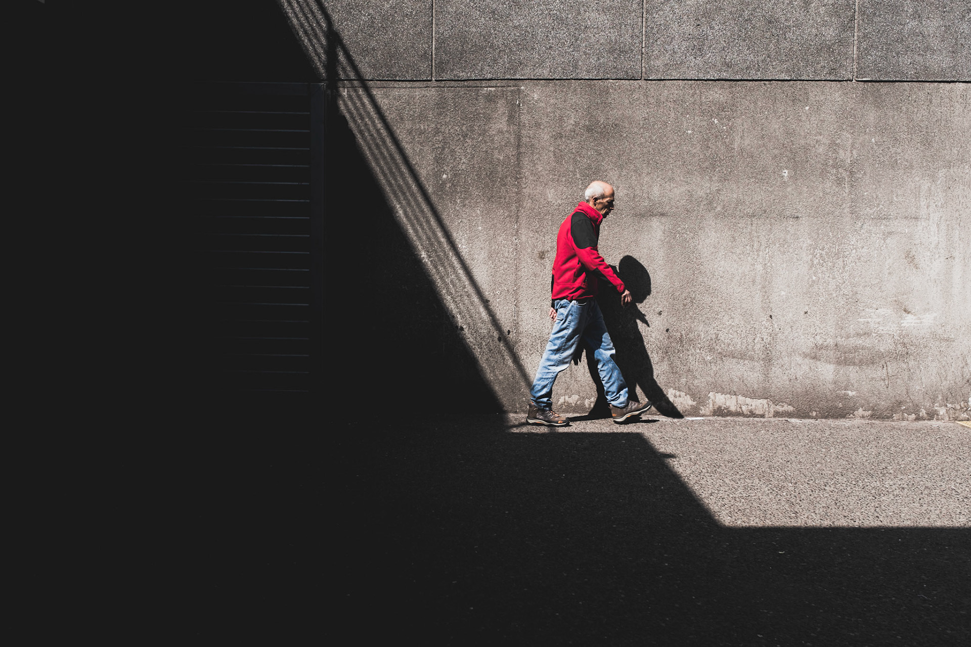 A man walking away from the shadows