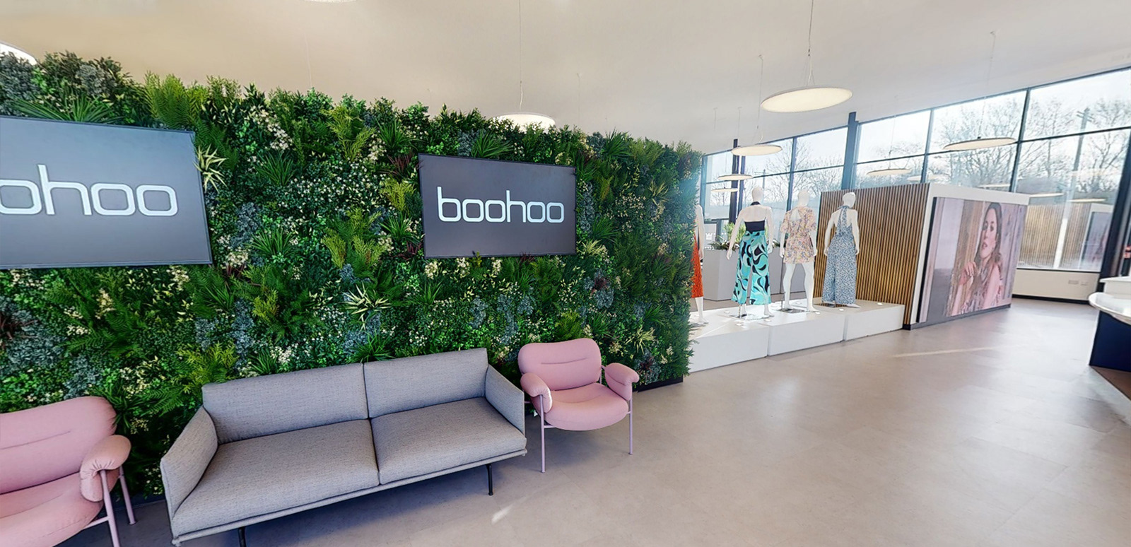 Photo of the foyer showing digital screens and foliage