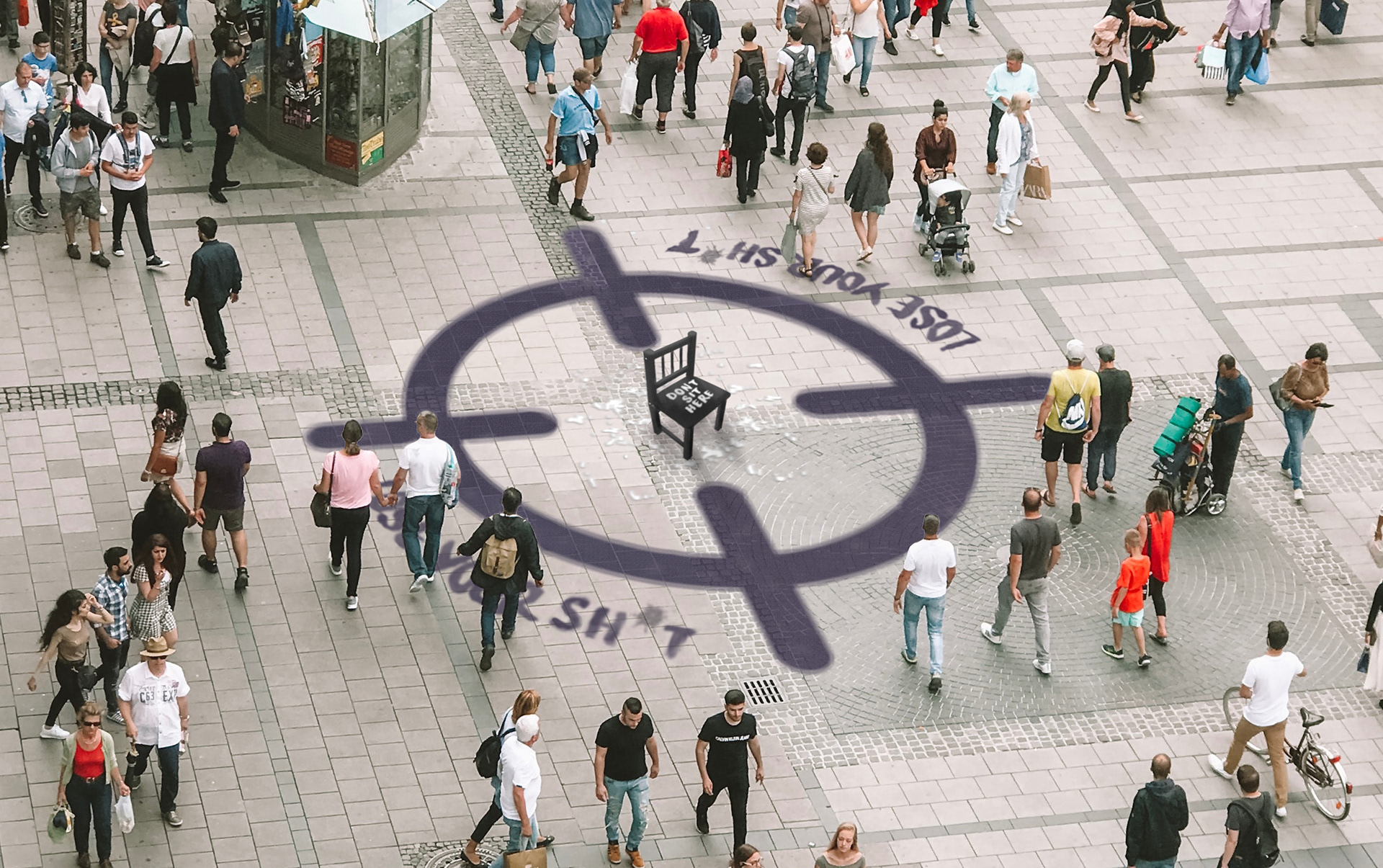 A black chair placed in a busy highstreet, surrounded by a large purple target painted on the floor