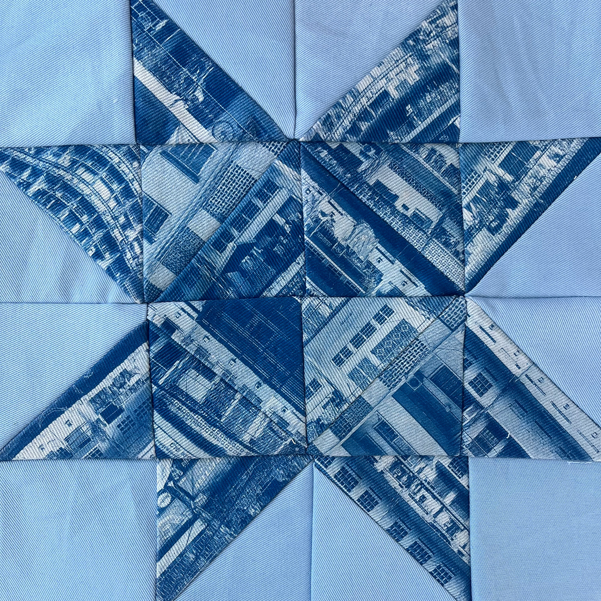 This piece uses images of Cambodian shophouses and heritage apartment buildings, like the Angkor Meanchey building, to create abstract geometric shapes. I sewed these cyanotype prints into a Sawtooth Star quilt block.