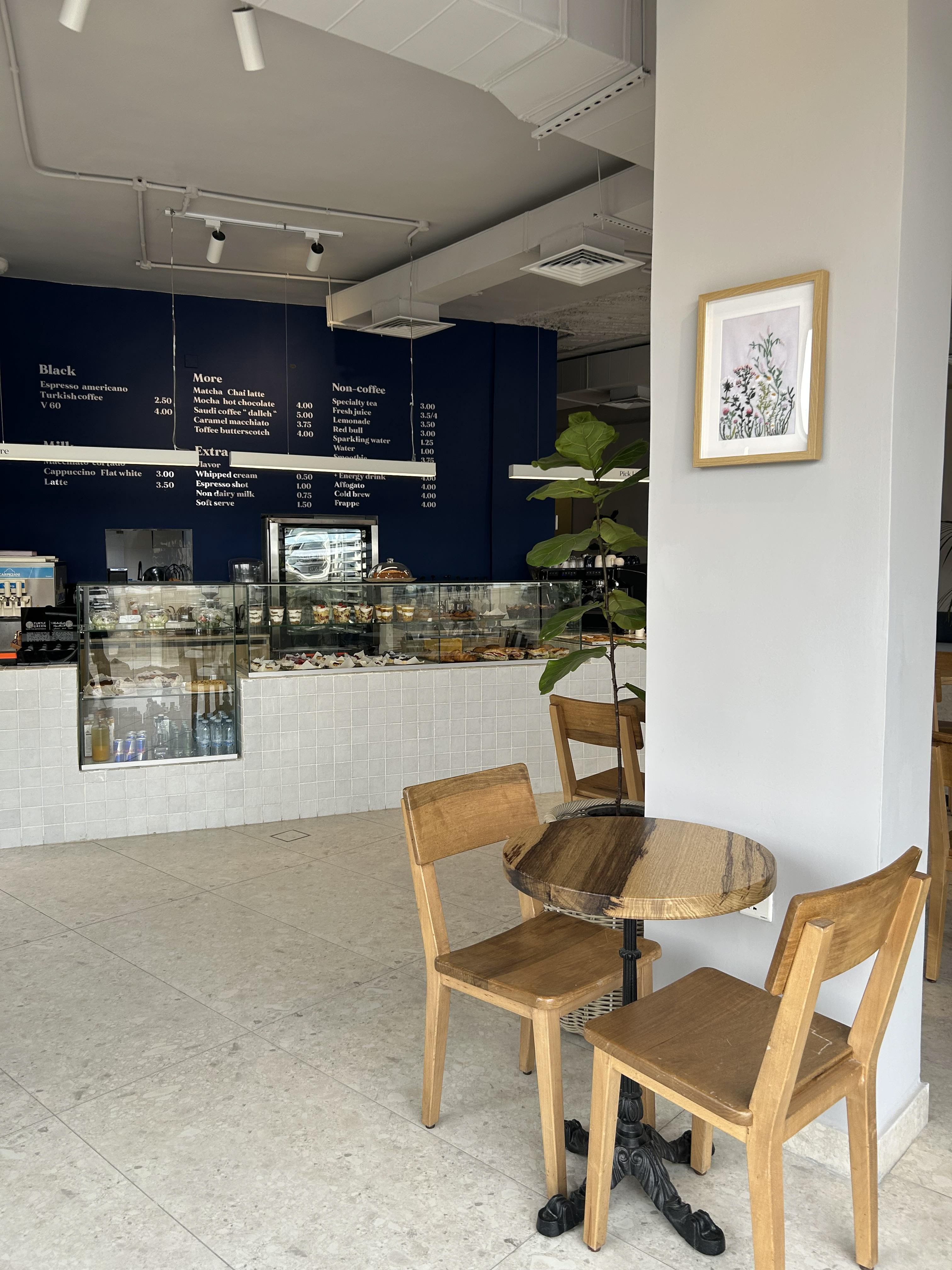 Azul bakery and coffee house interior design in Amman Jordan. Exposed ceiling, modern, minimalist, plants, wood.