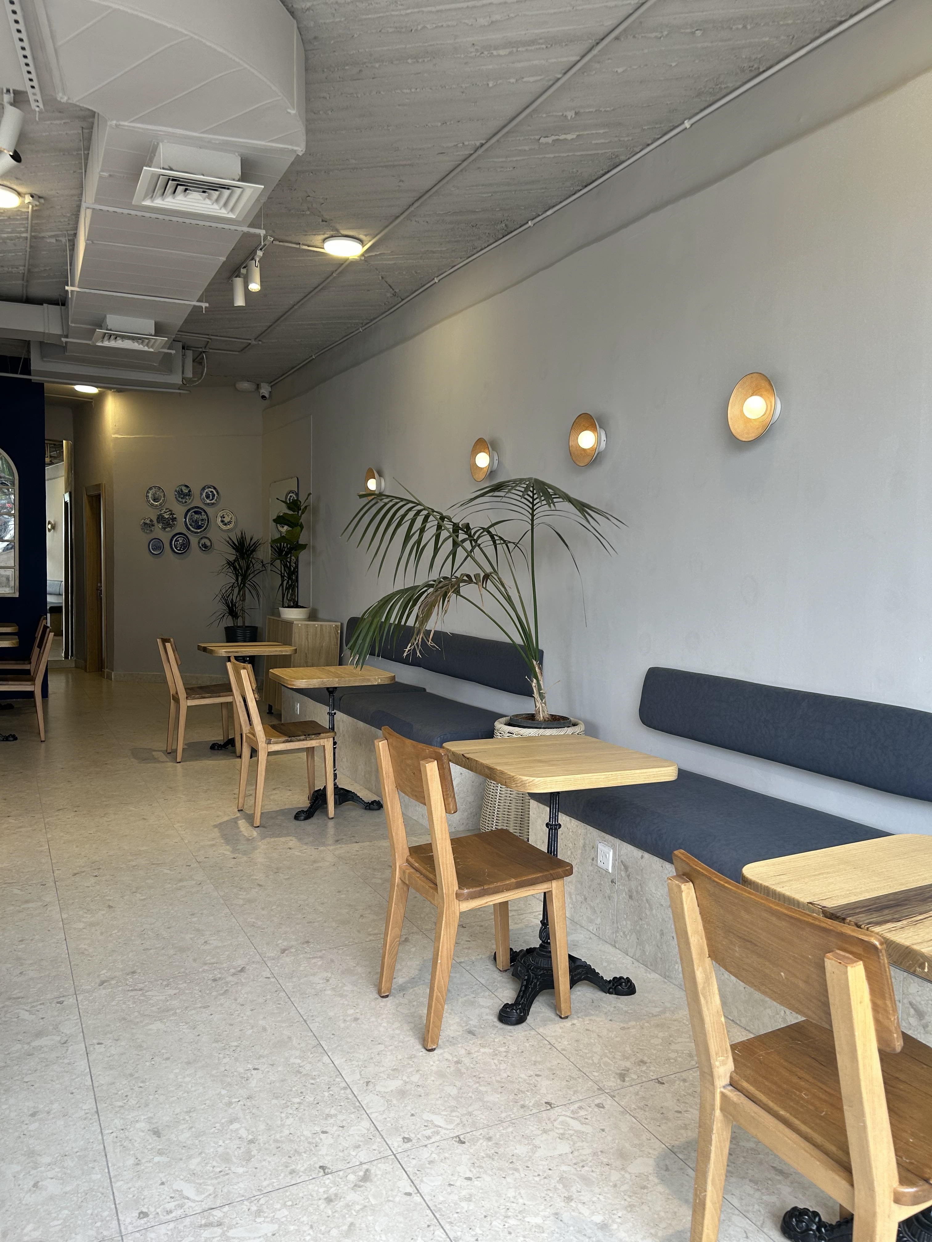 Azul bakery and coffee house interior design in Amman Jordan. Exposed ceiling, modern, minimalist, plants, wood.