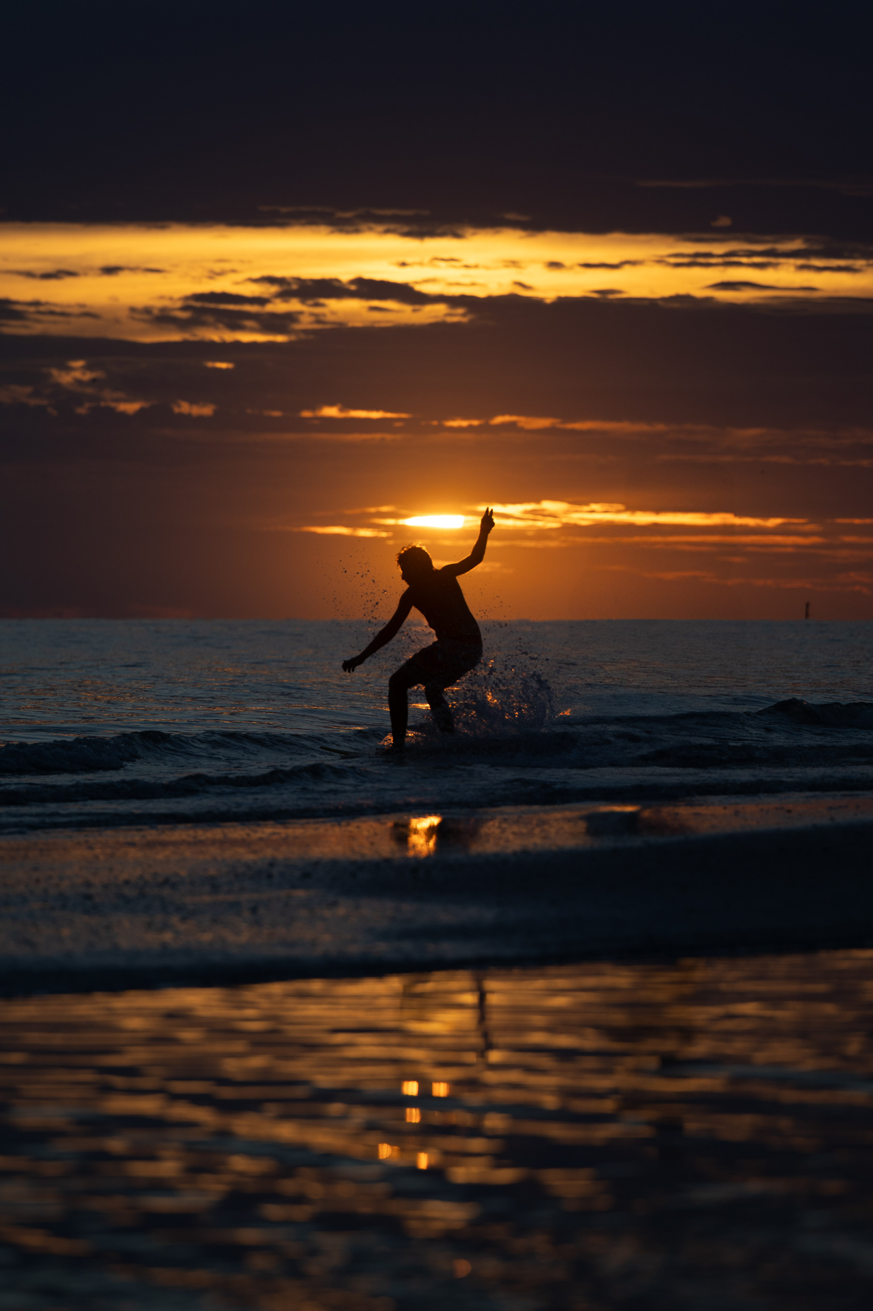 Skimboarding at sunset