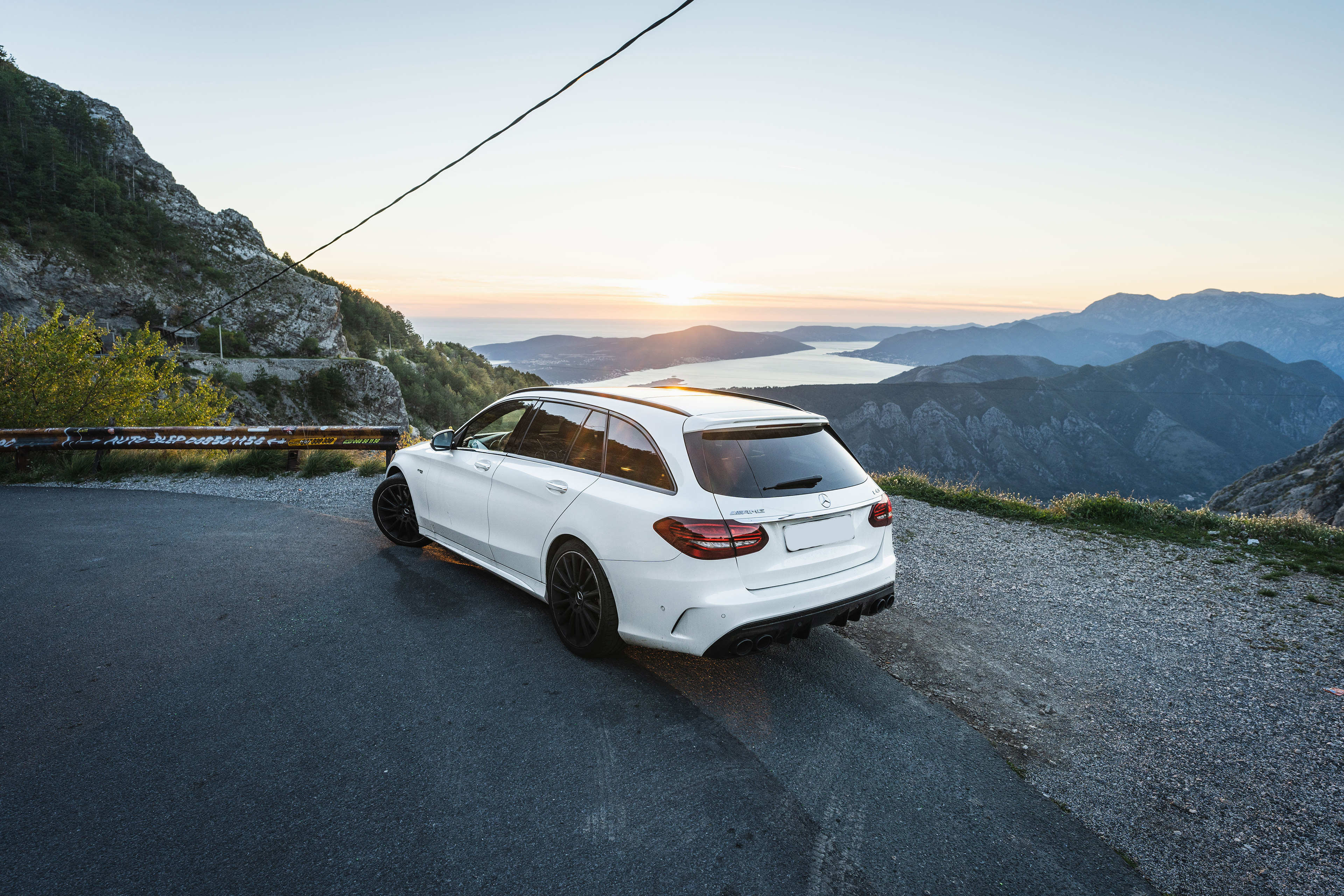 Mercedes-AMG C43 with the Bay of Kotor in Montenegro in Background at sunset