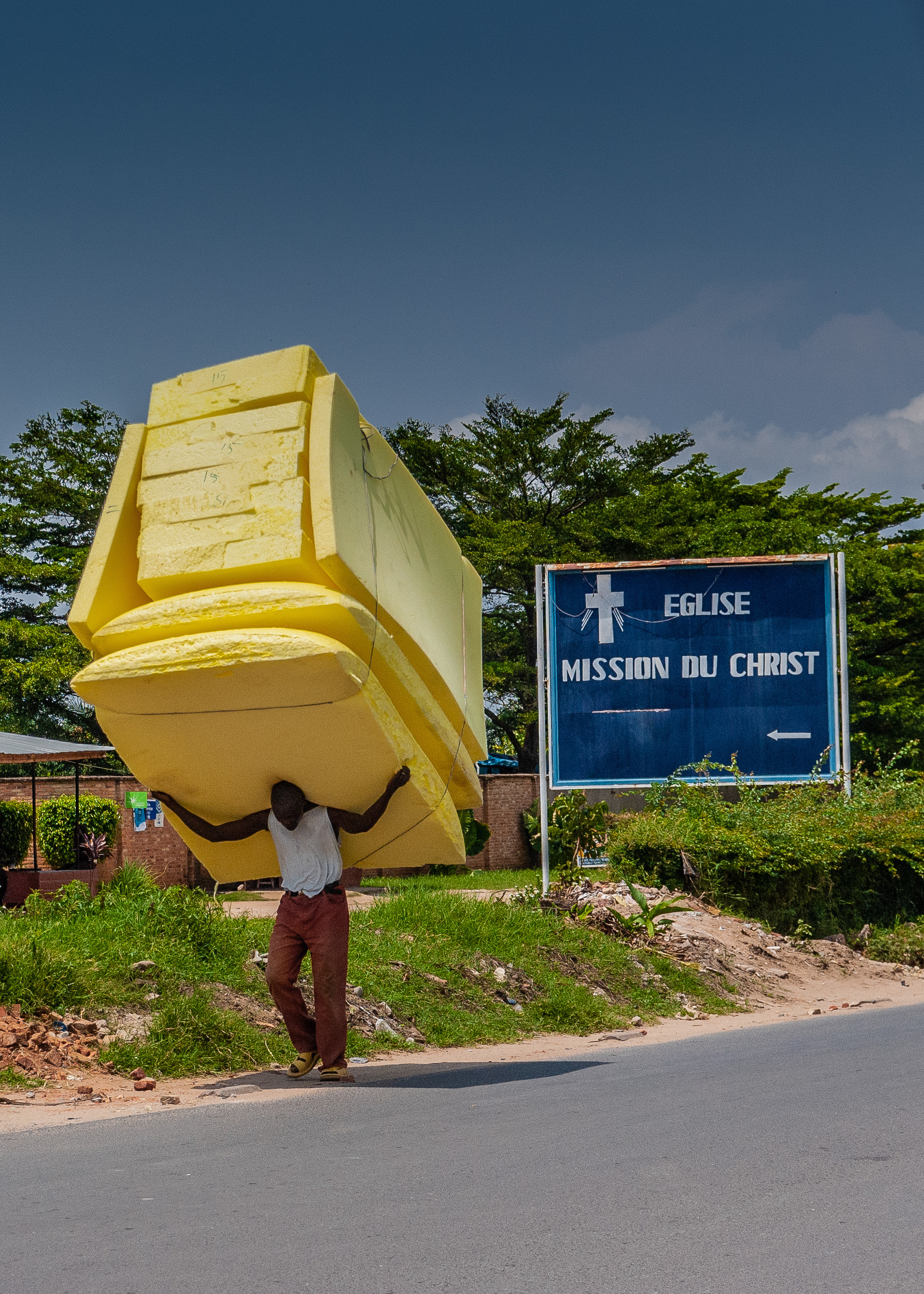 A Man Carrying 11 Mattresses On His Head