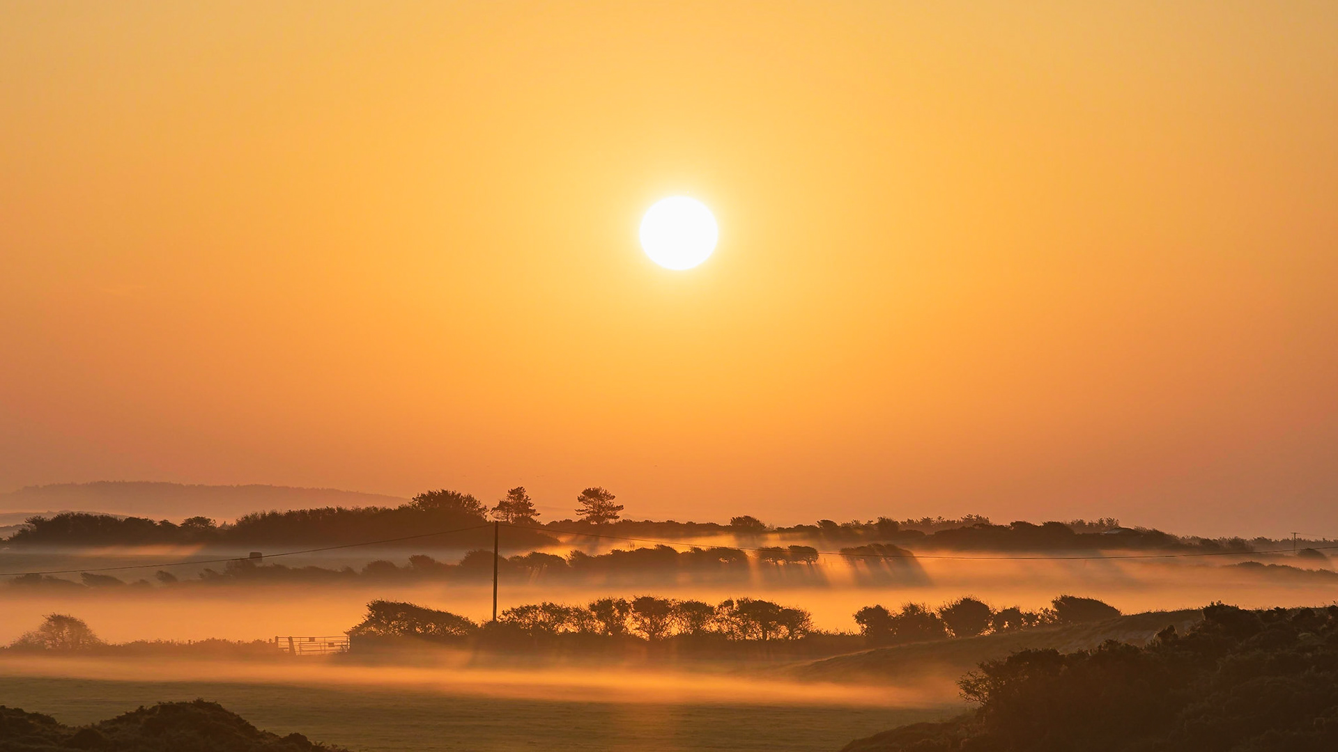 Sunrise over Holy Island, Anglesey on a misty morning.