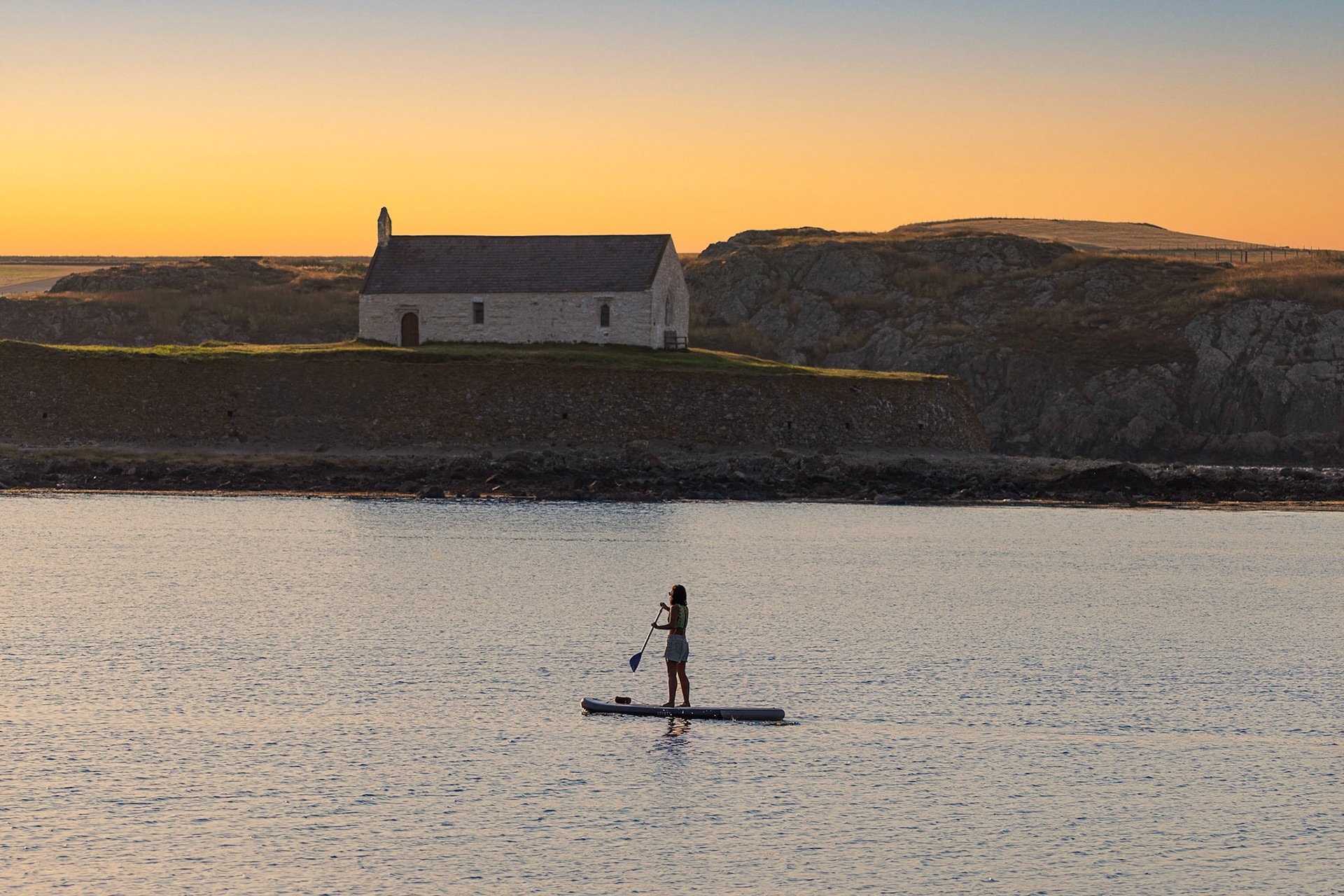 Paddle Boarder at Porth Cwyfan