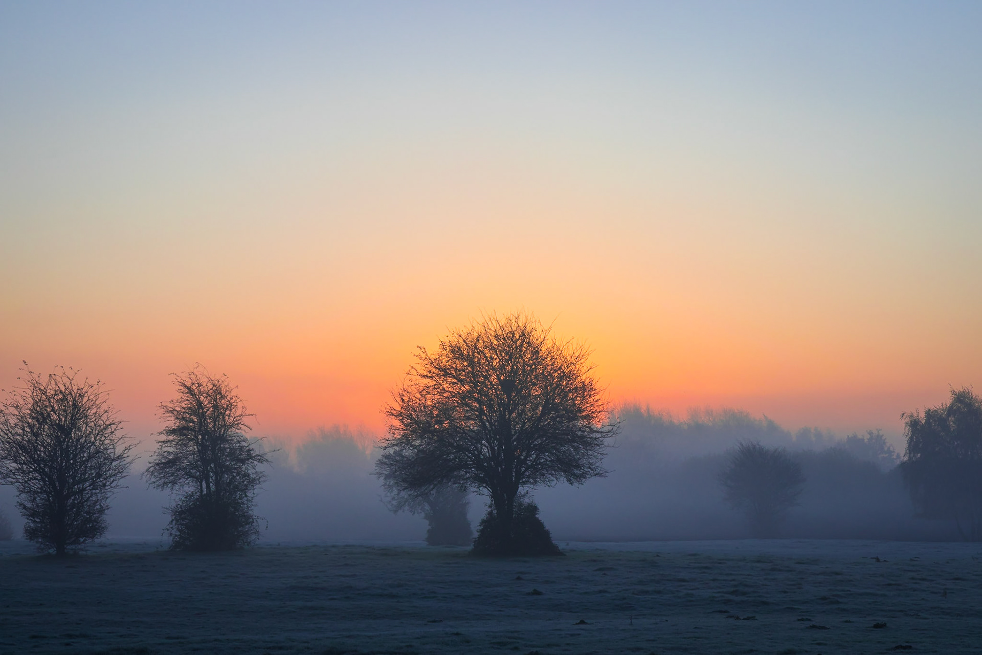 Early morning winter sunrise over Jack Lane Farm fields, Flixton, Manchester, United Kingdom.