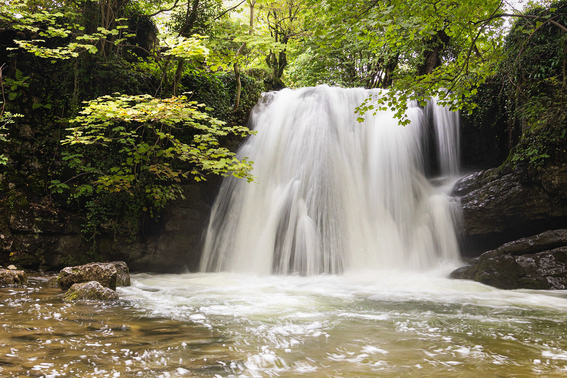Janet's Foss waterfall in Malham after heavy rain.