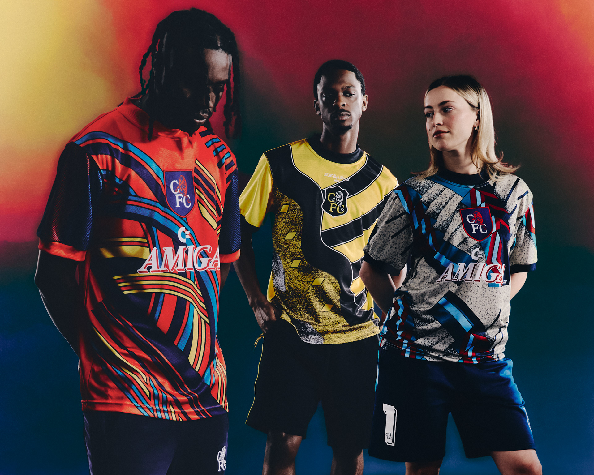 3 chelsea football players wearing their vintage collection "Play loud", very bright football (soccer jerseys) inspired by the 90s goal keeper kits from the club.