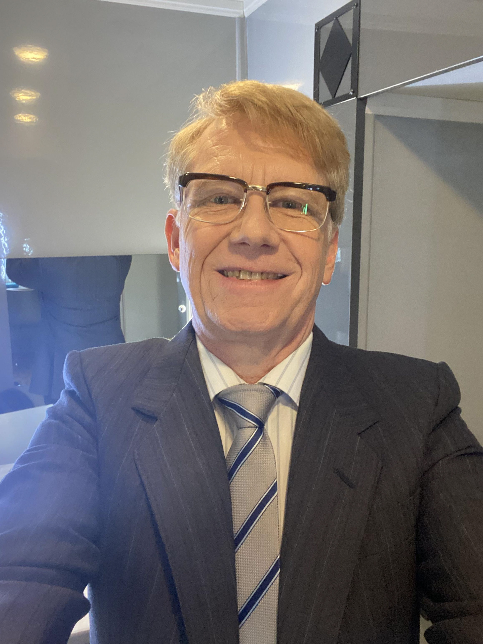 A selfie in costume - retro glasses, retro hair and a retro suit and tie.