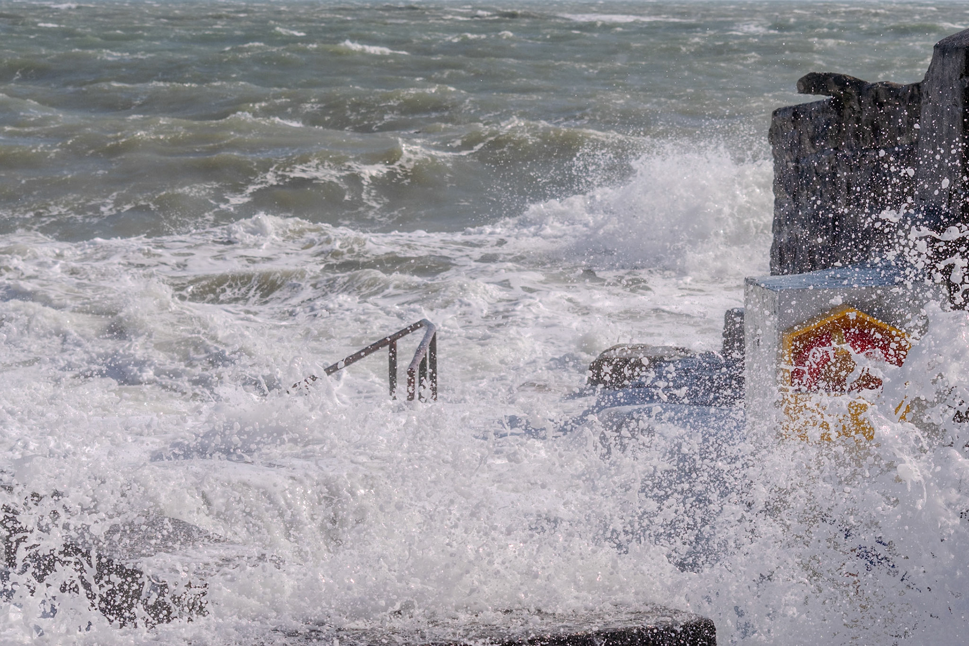 A study in contrast and chaos—where the relentless rhythm of the tide meets the immovable granite of the Dublin coast.