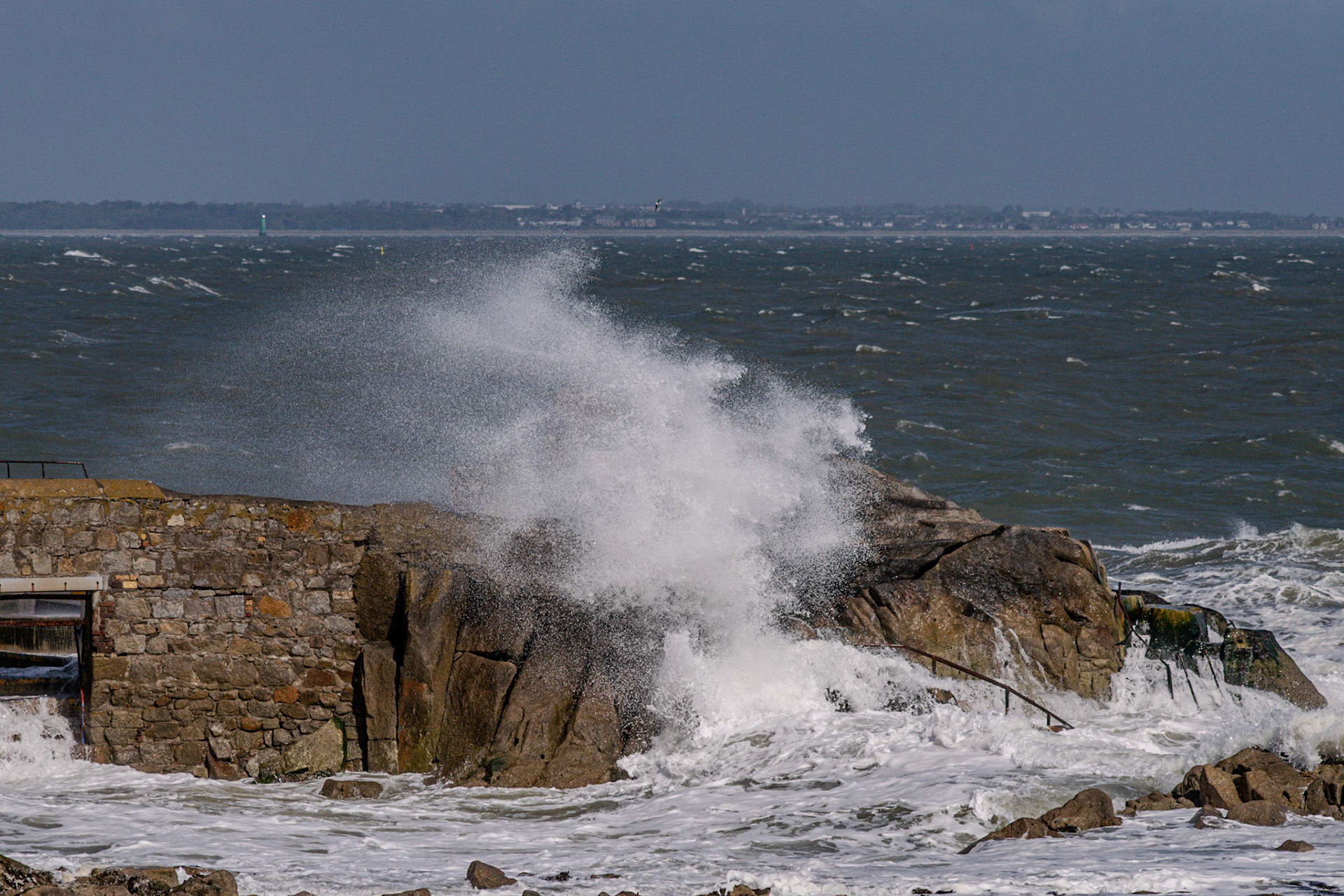 A study in contrast and chaos—where the relentless rhythm of the tide meets the immovable granite of the Dublin coast.