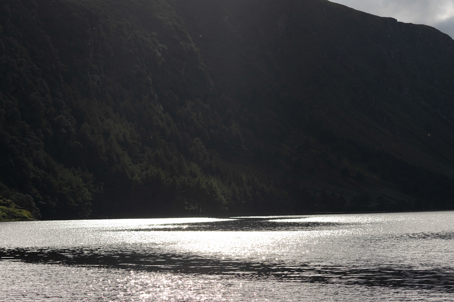 Wandering through the ancient, moss-covered ruins and weathered high crosses of Glendalough's 6th-century monastic city.
