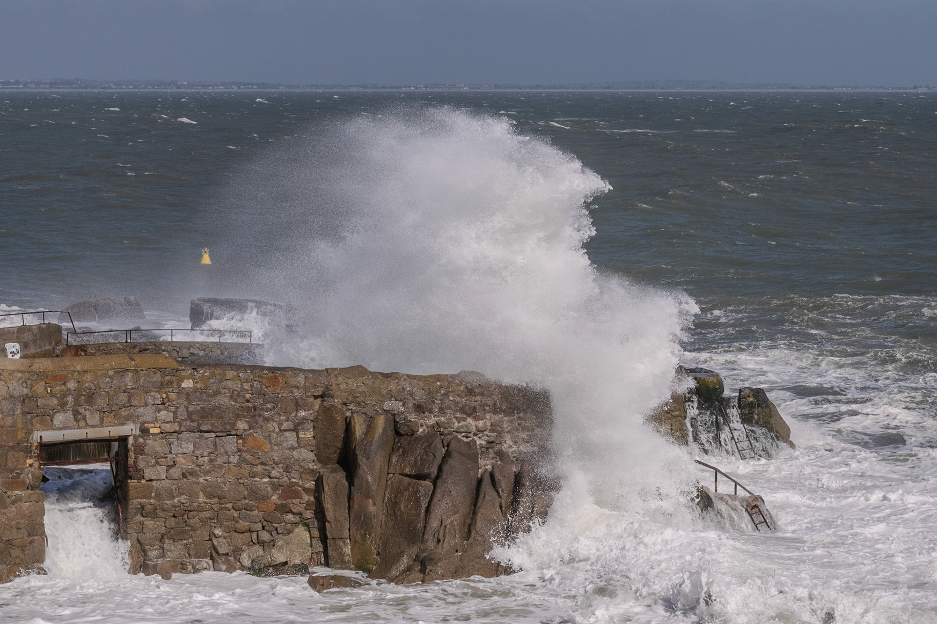 A study in contrast and chaos—where the relentless rhythm of the tide meets the immovable granite of the Dublin coast.