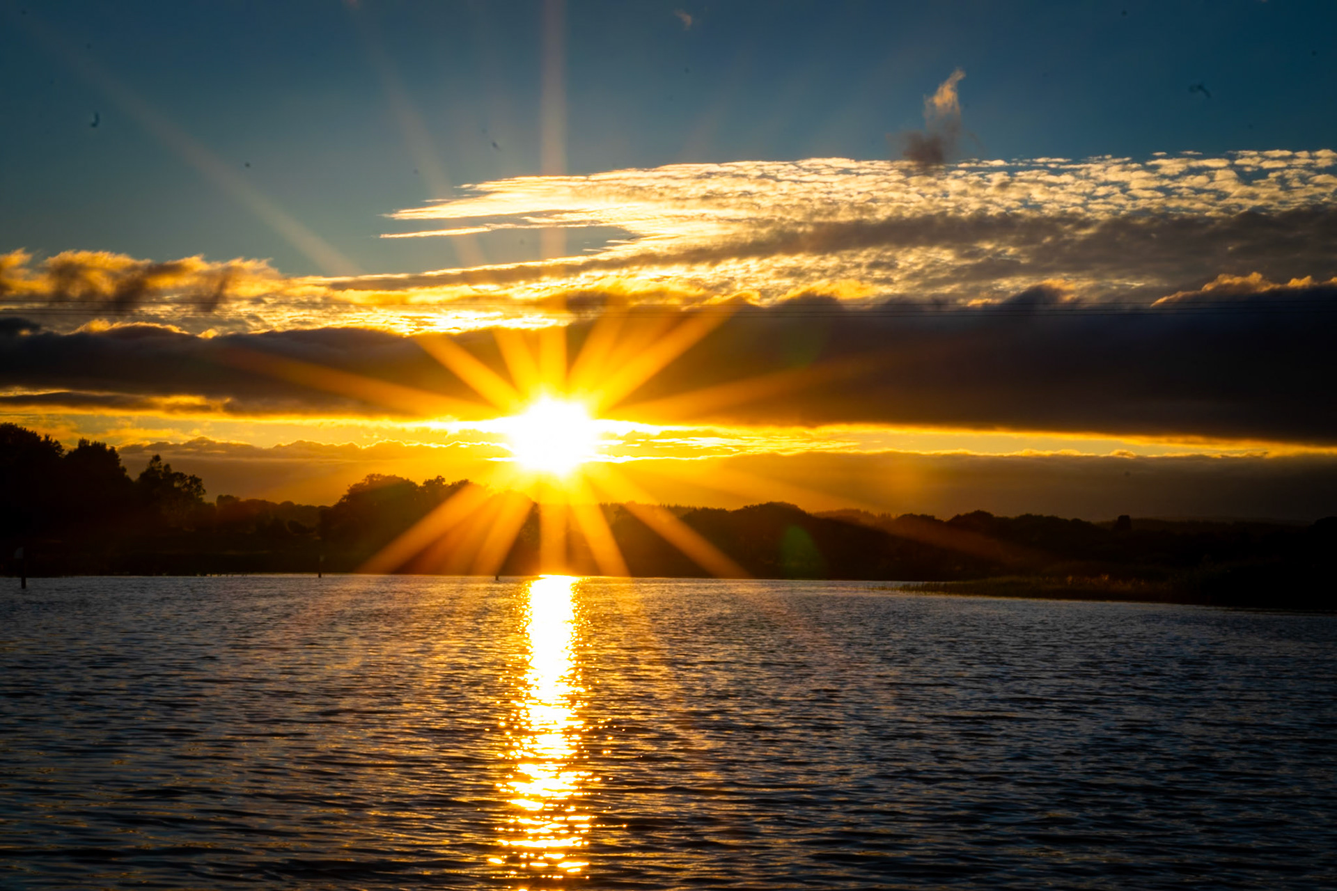 Watching the sun dip below the horizon over Ireland’s longest river, where the evening light turns the water into a mirror of gold.
