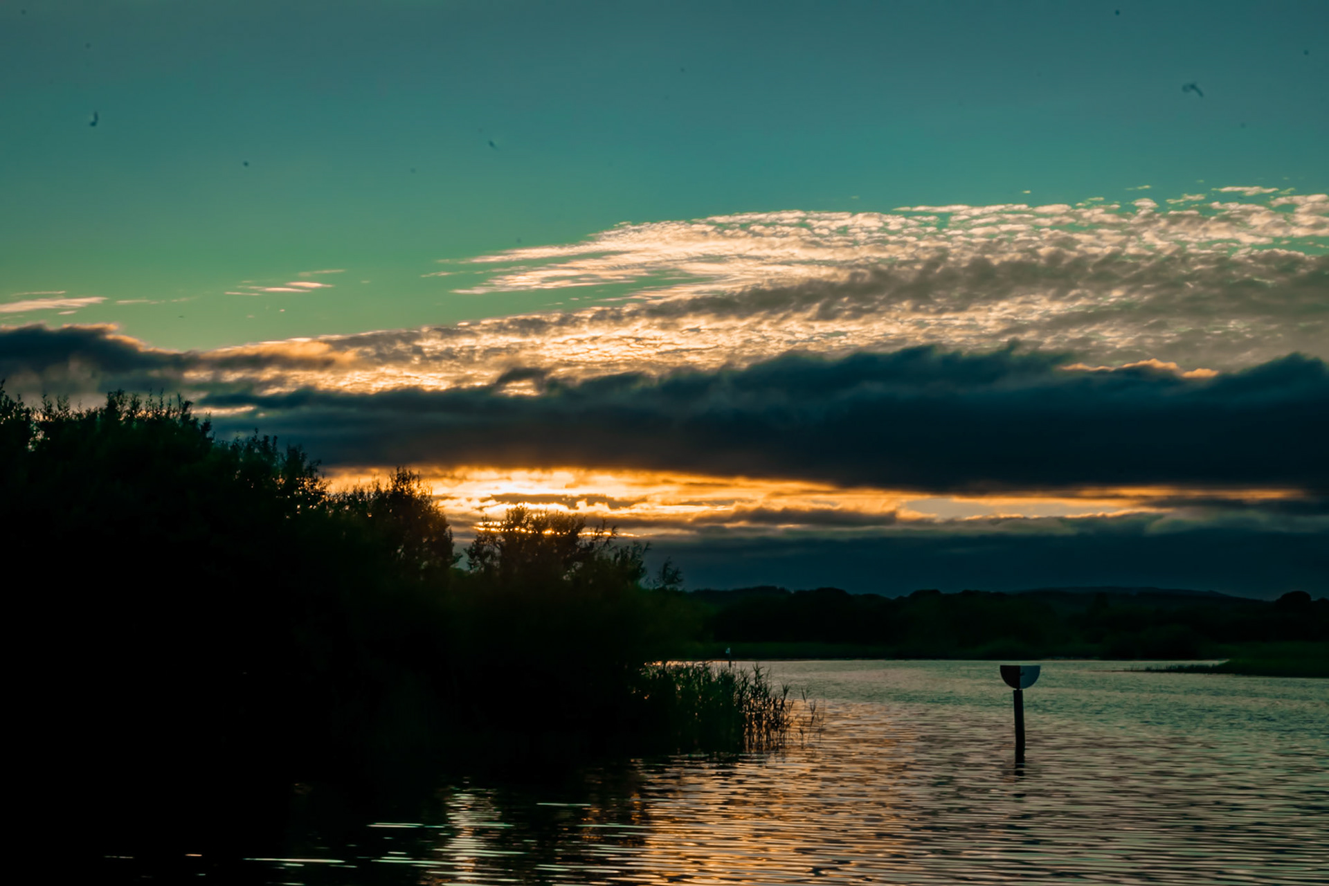 Watching the sun dip below the horizon over Ireland’s longest river, where the evening light turns the water into a mirror of gold.