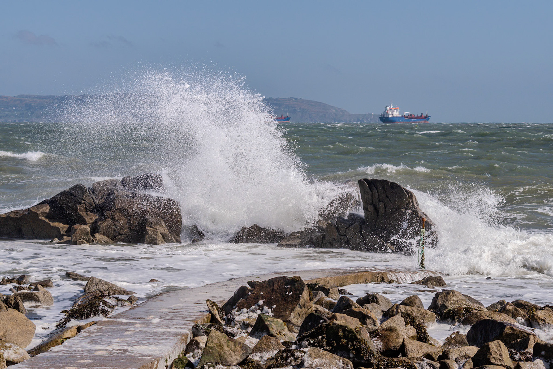 A study in contrast and chaos—where the relentless rhythm of the tide meets the immovable granite of the Dublin coast.