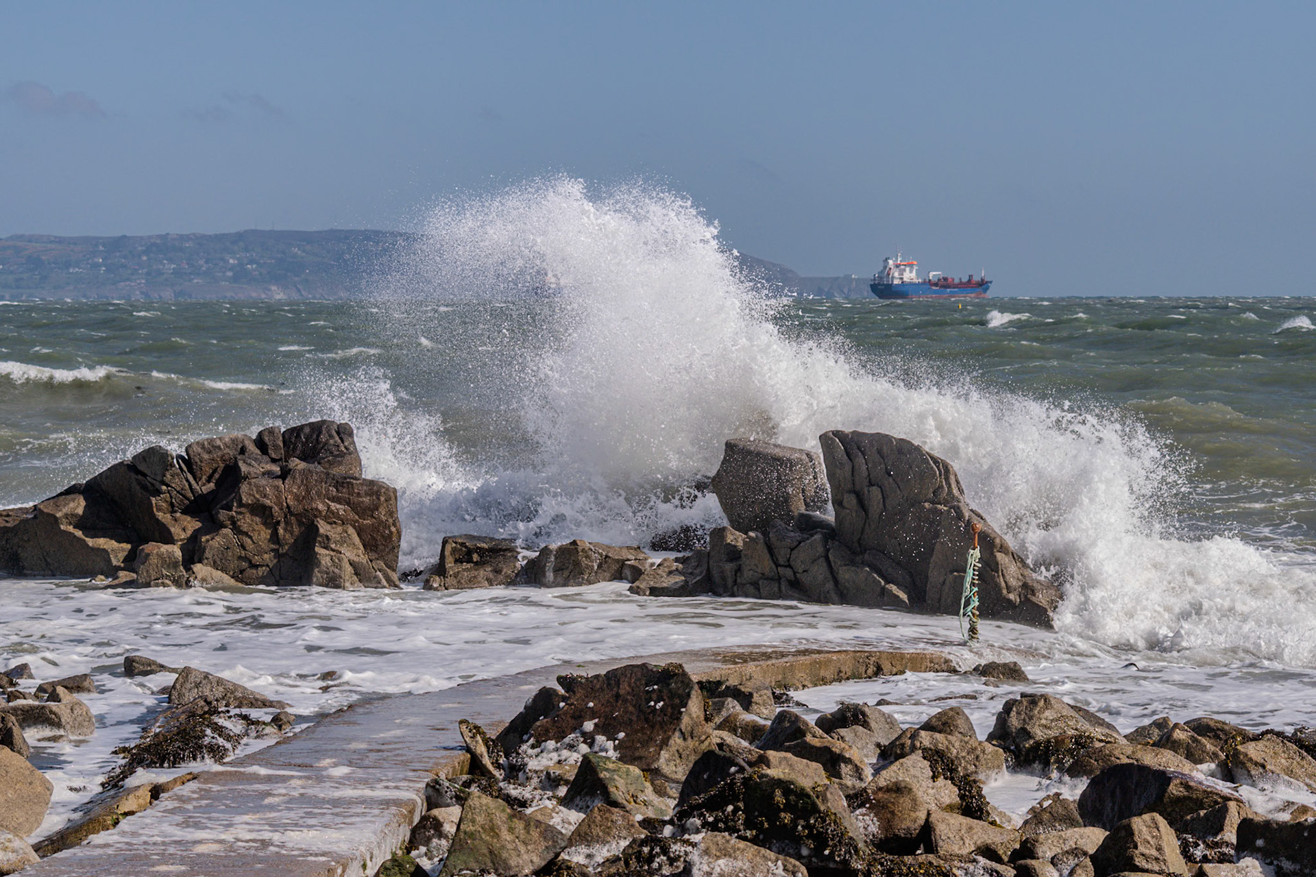 A study in contrast and chaos—where the relentless rhythm of the tide meets the immovable granite of the Dublin coast.