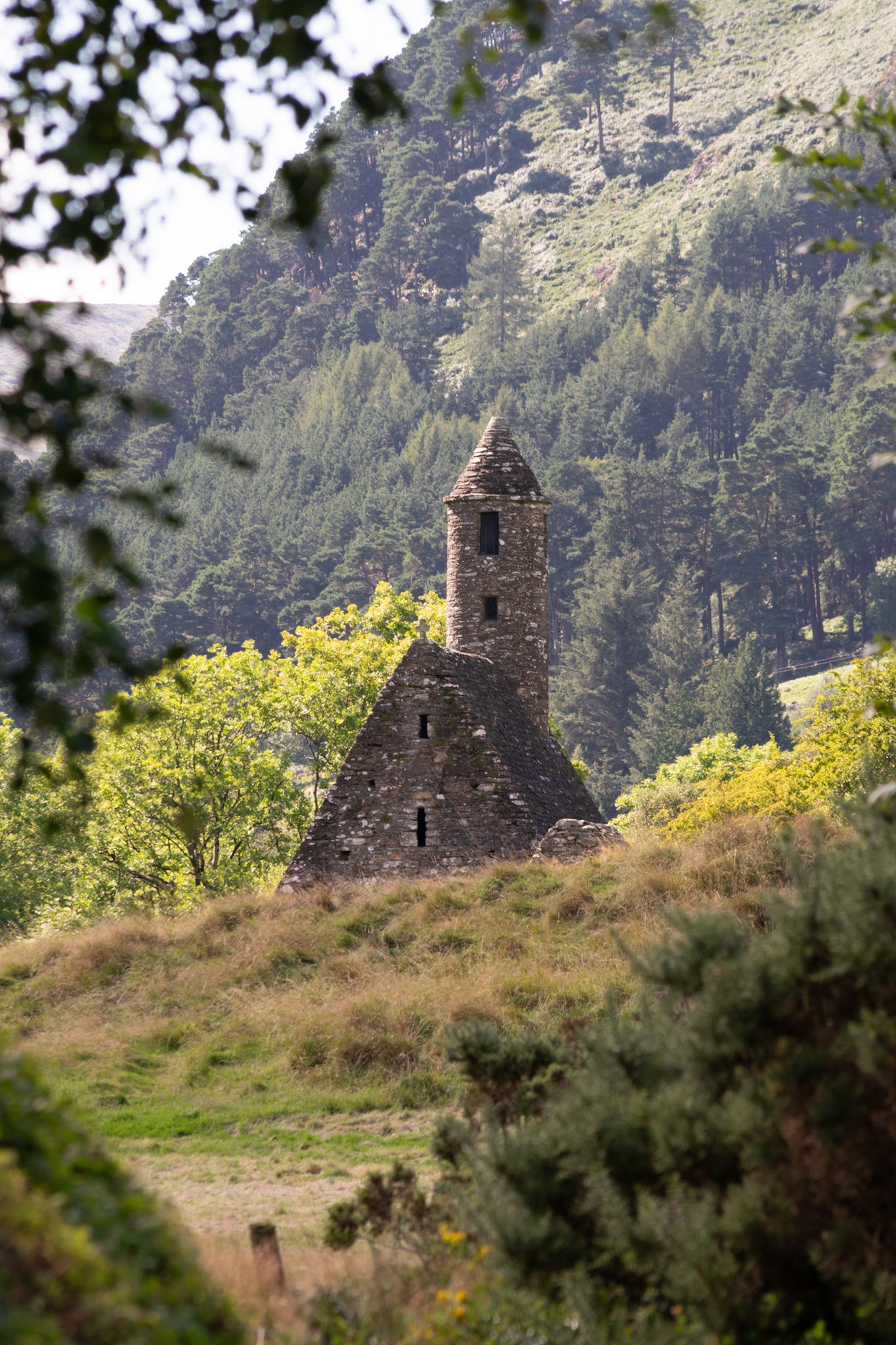 Wandering through the ancient, moss-covered ruins and weathered high crosses of Glendalough's 6th-century monastic city.