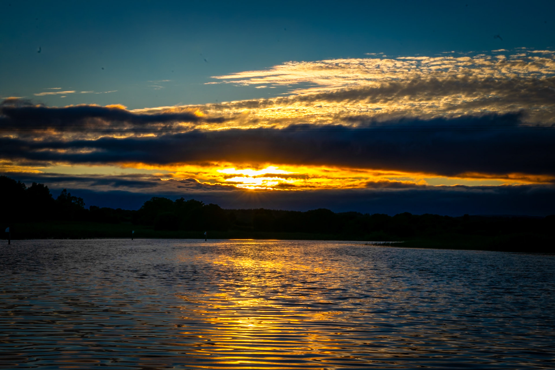Watching the sun dip below the horizon over Ireland’s longest river, where the evening light turns the water into a mirror of gold.