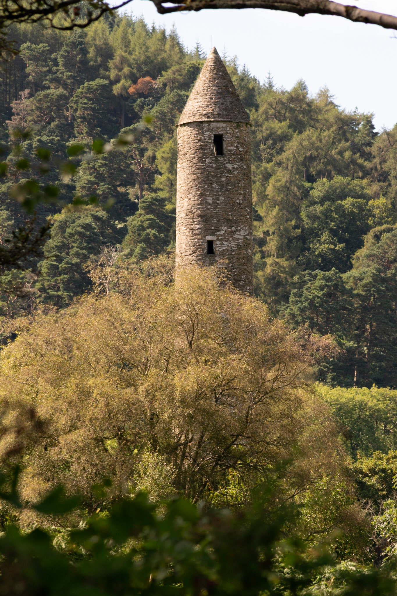 Wandering through the ancient, moss-covered ruins and weathered high crosses of Glendalough's 6th-century monastic city.
