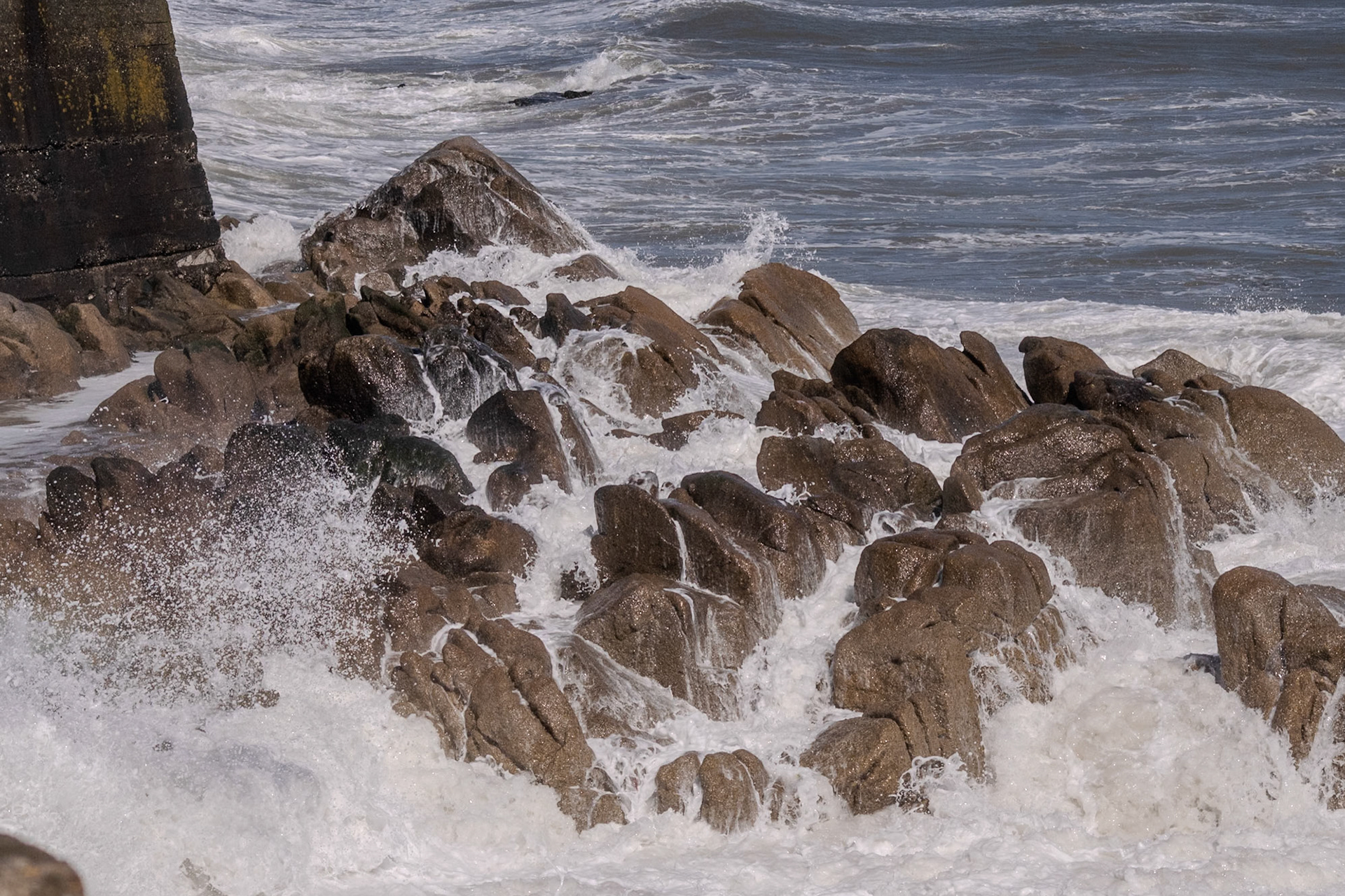 A study in contrast and chaos—where the relentless rhythm of the tide meets the immovable granite of the Dublin coast.