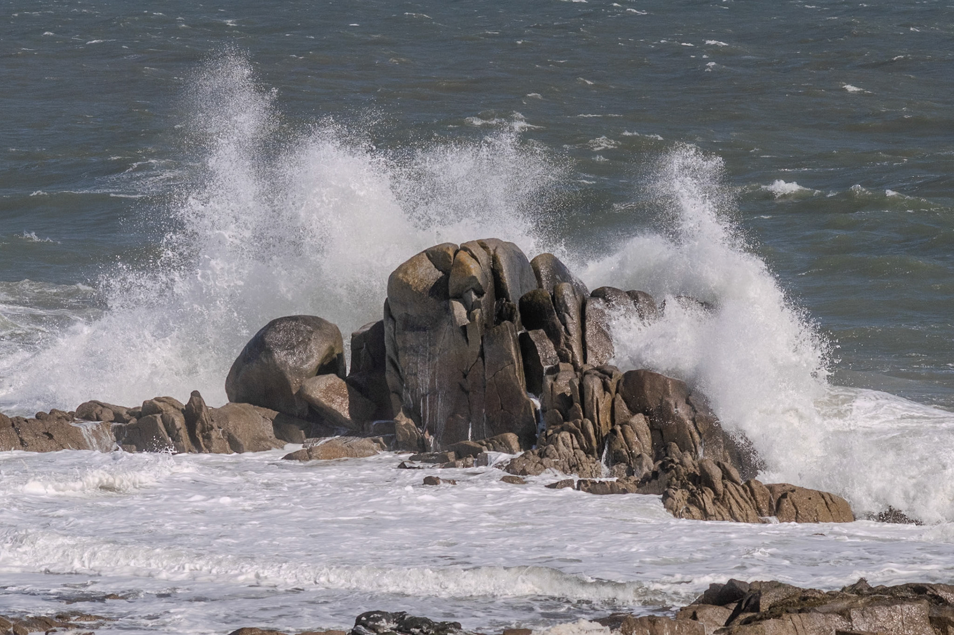 A study in contrast and chaos—where the relentless rhythm of the tide meets the immovable granite of the Dublin coast.