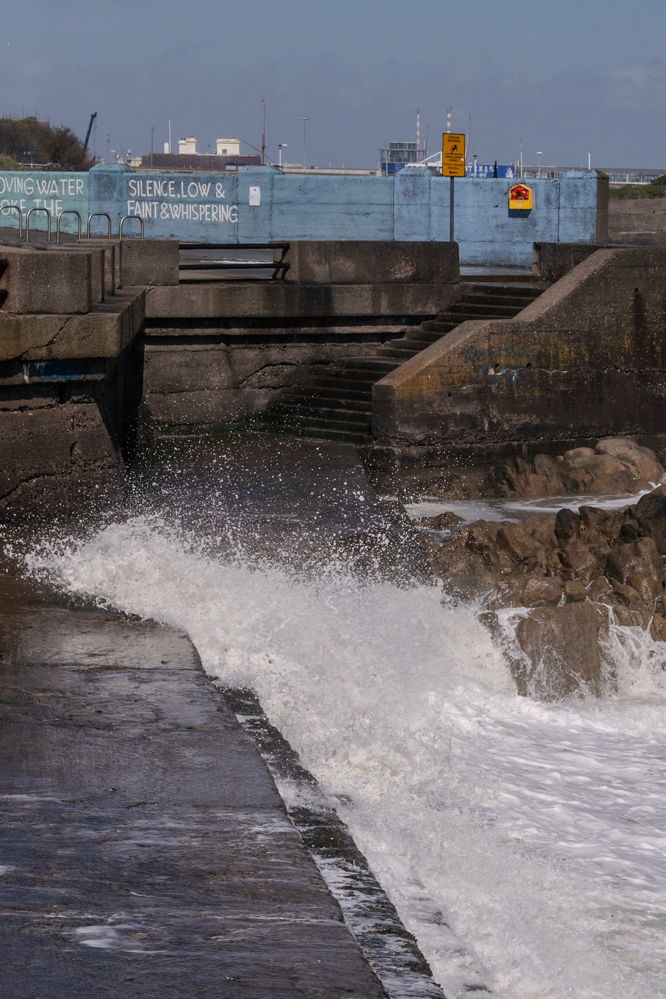 A study in contrast and chaos—where the relentless rhythm of the tide meets the immovable granite of the Dublin coast.