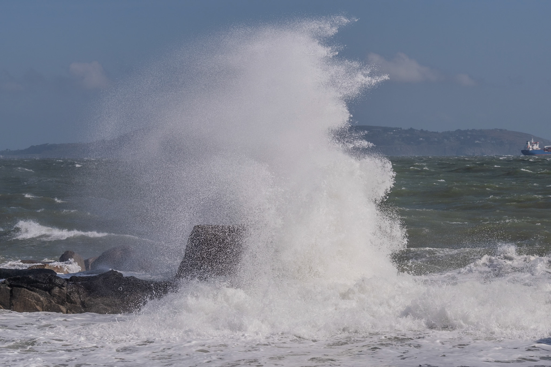 A study in contrast and chaos—where the relentless rhythm of the tide meets the immovable granite of the Dublin coast.