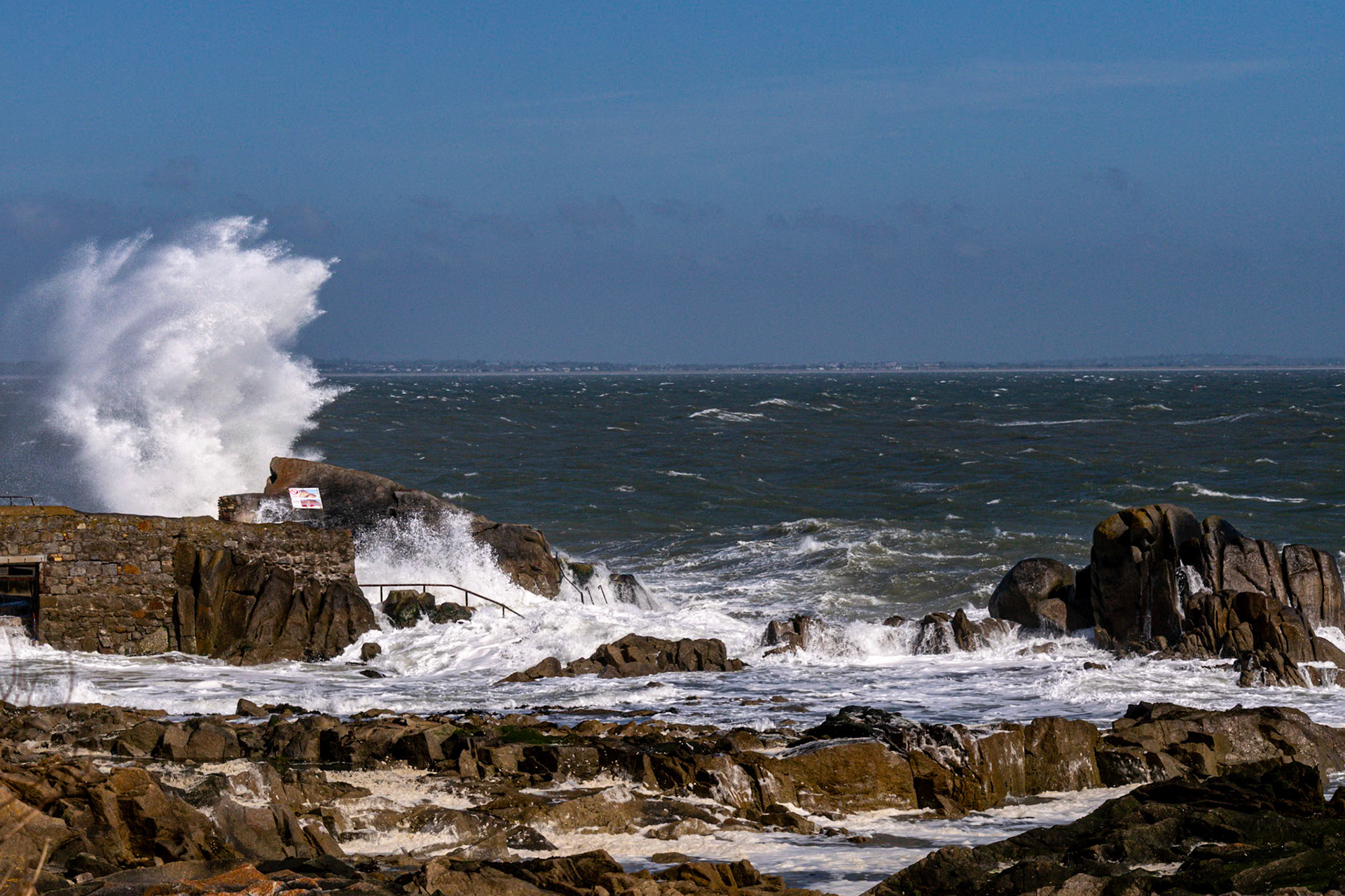 A study in contrast and chaos—where the relentless rhythm of the tide meets the immovable granite of the Dublin coast.