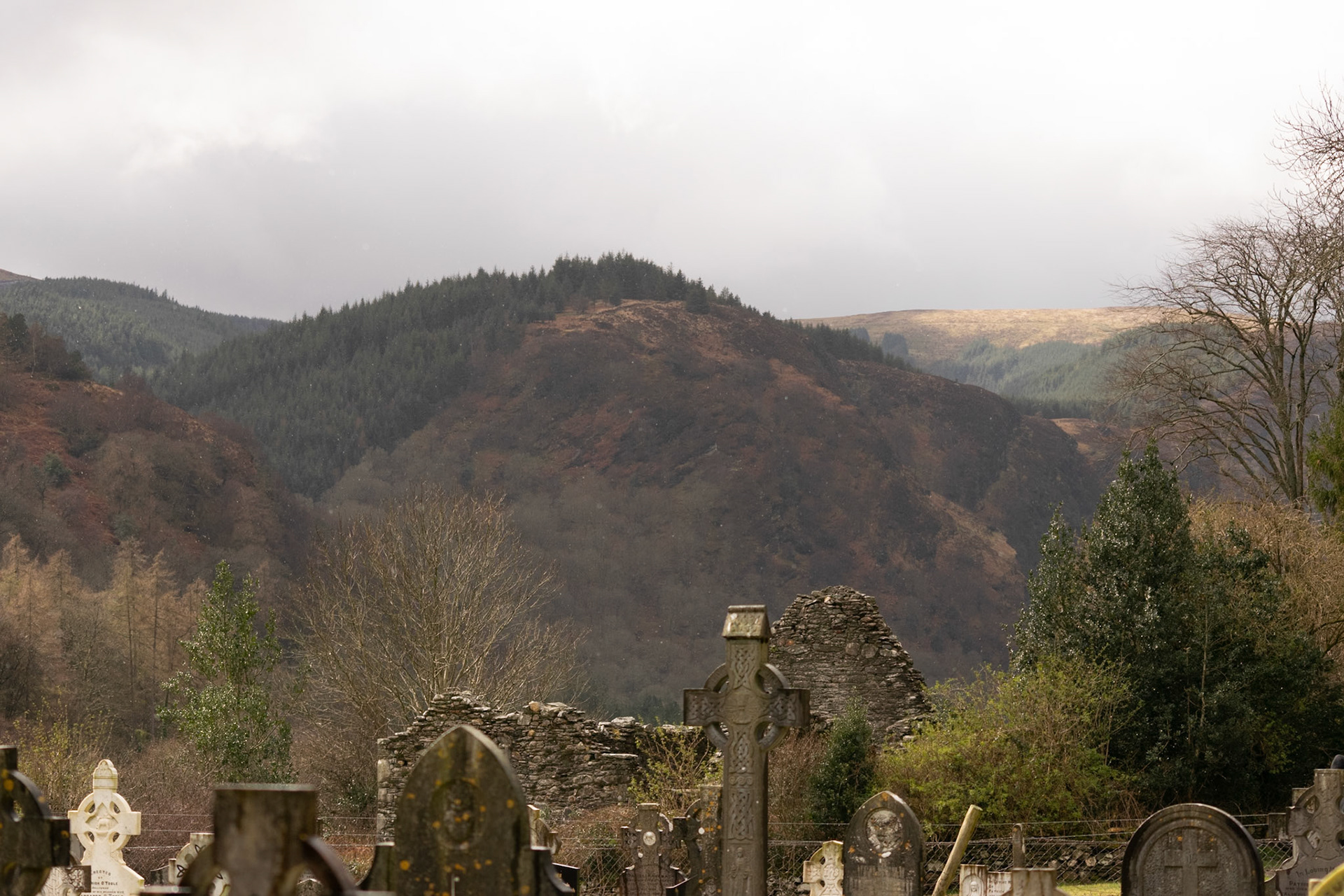 Wandering through the ancient, moss-covered ruins and weathered high crosses of Glendalough's 6th-century monastic city.