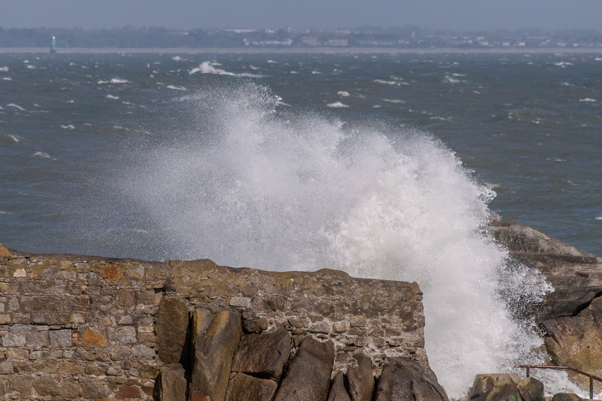 A study in contrast and chaos—where the relentless rhythm of the tide meets the immovable granite of the Dublin coast.