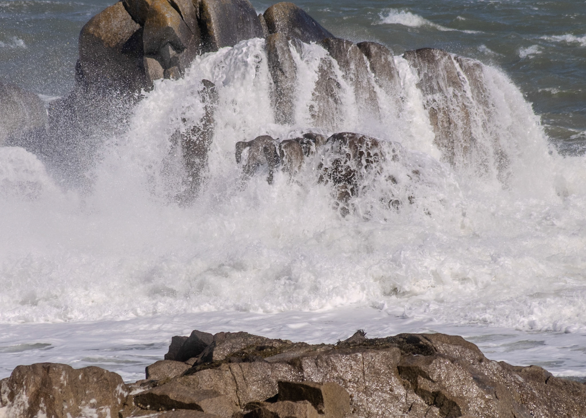 A study in contrast and chaos—where the relentless rhythm of the tide meets the immovable granite of the Dublin coast.