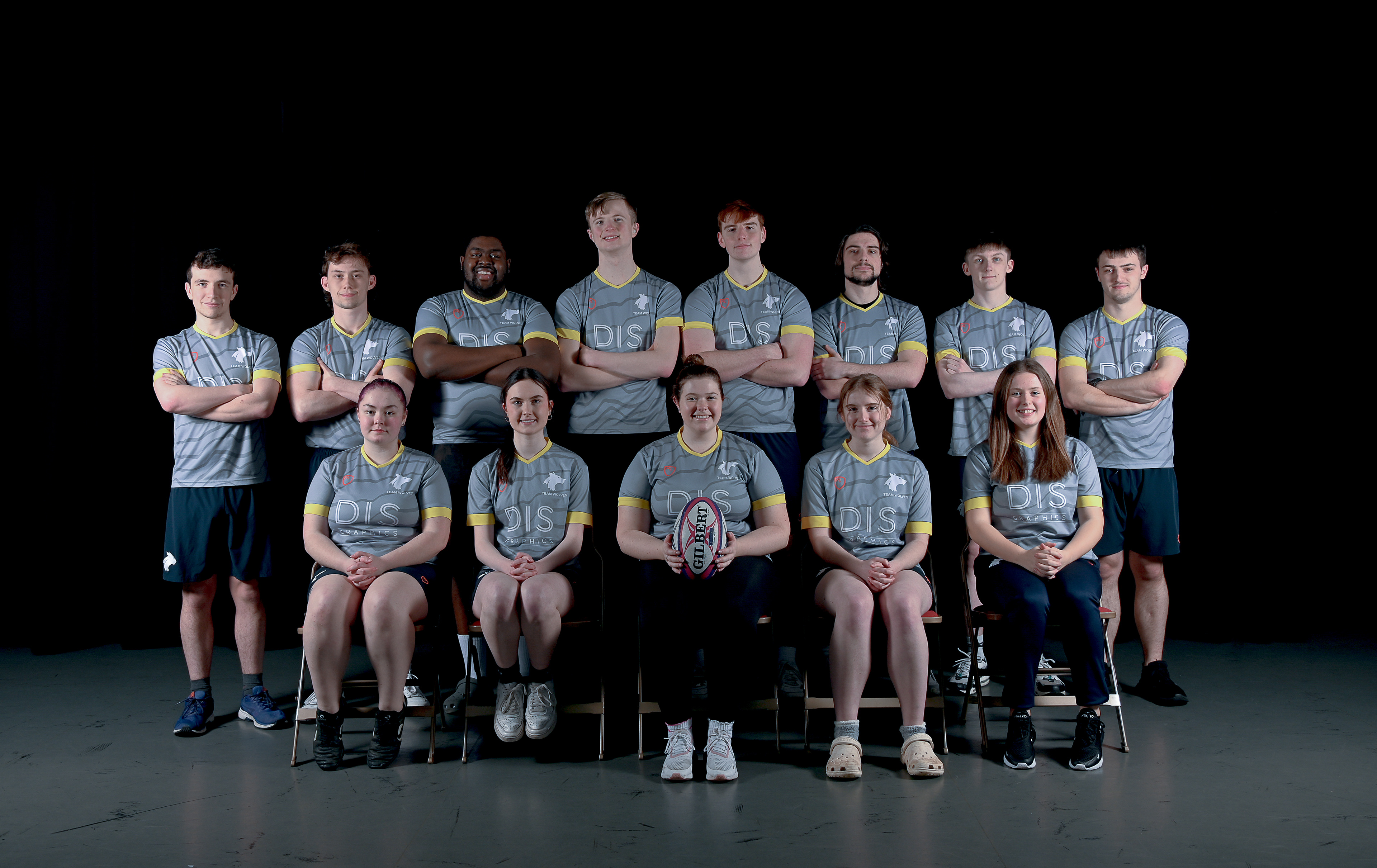 A team of 13 men and women in sports attire