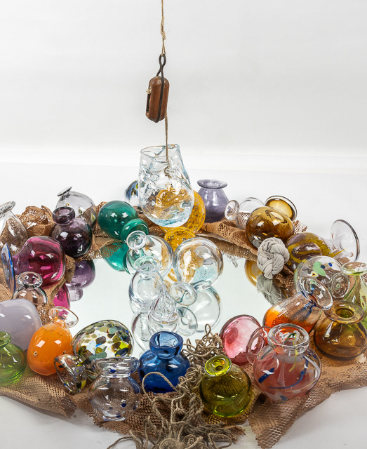 Portfolio Shots - A. Finnegan Glasslots of glass pots placed in a circle on top of a mirror, a further glass pot is suspended above the others