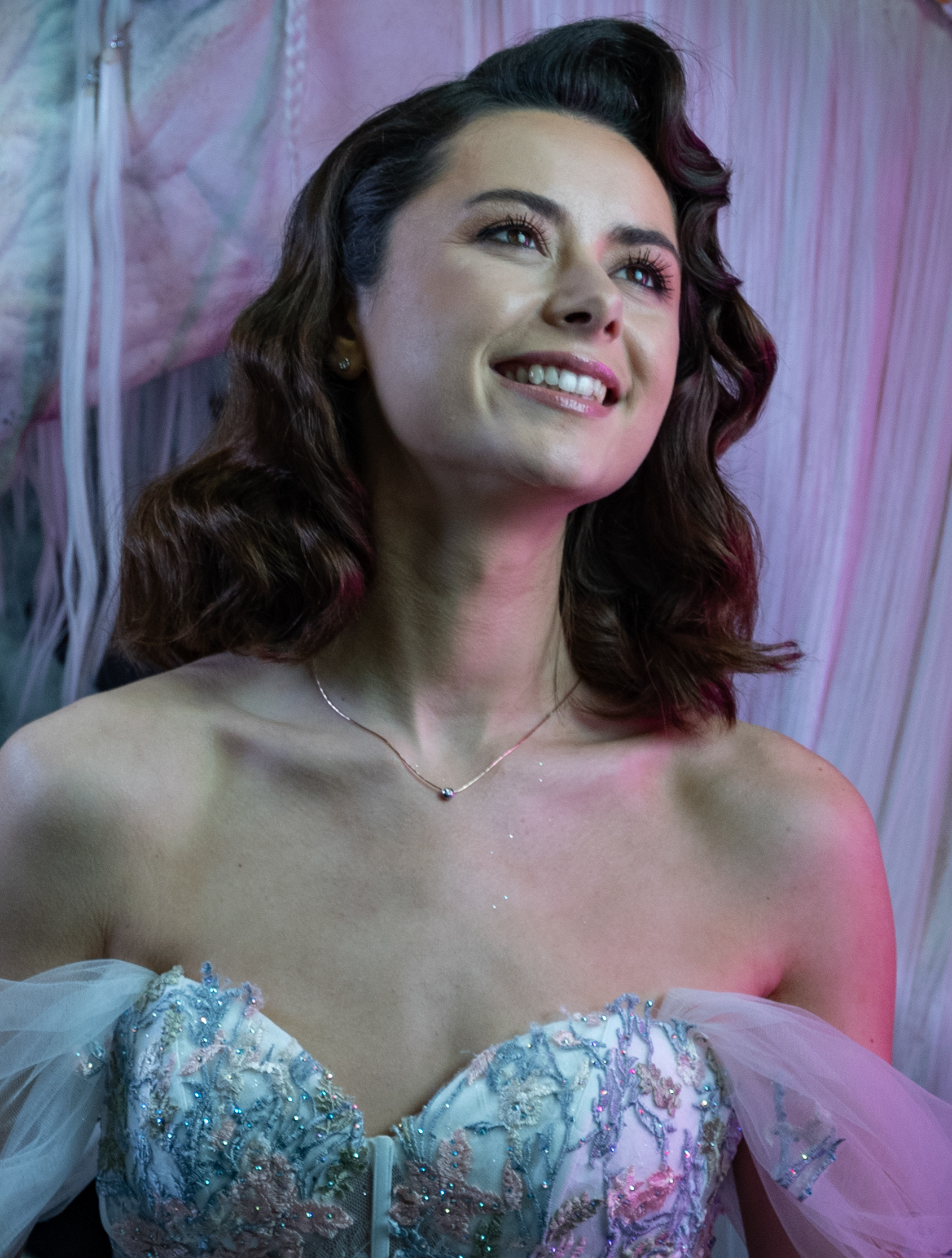 shooting at The Photography & Video Show 2024 - A young woman gazes up and smiles 