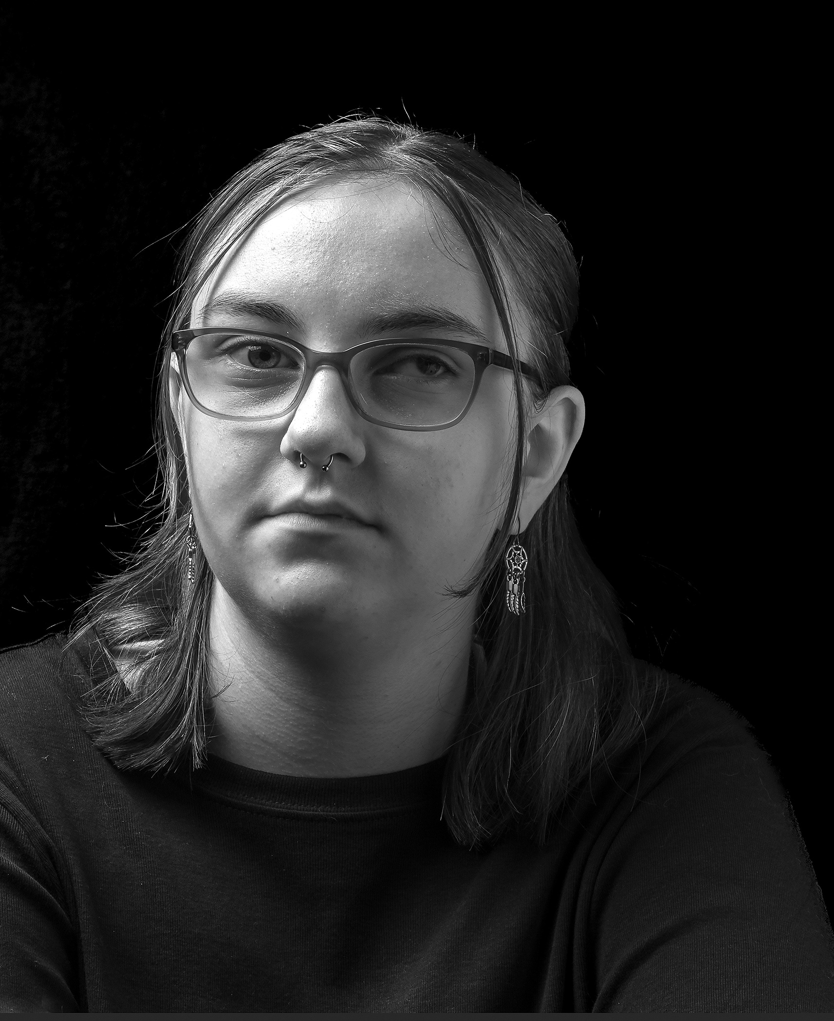 Cassidy - A young woman looks straight at the camera she is wearing glasses
