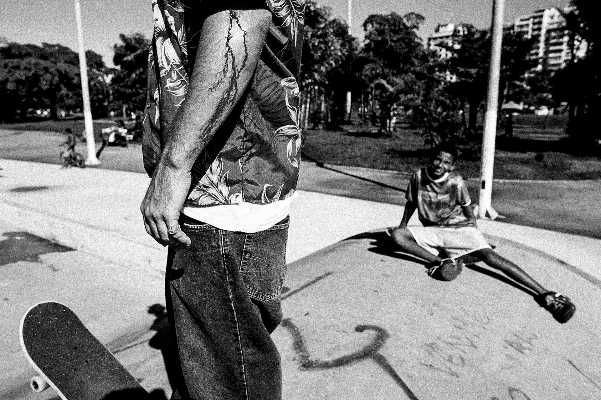 Leo Lopes with blood running down his forearm after falling from his skateboard at the flamengo concrete skatepark while a young skater looks on.Skateboarding and Surfing in Rio de Janeiro.Rio de Janeiro, Brazil population of approx 11.5 Million. The Flamenco concrete skate park is situated near Flamenco beach and entry is free. The Lagoa skatepark is in the Ipanema area of the city. Ipanema beach is one of the most popular surf spots in the Rio area.