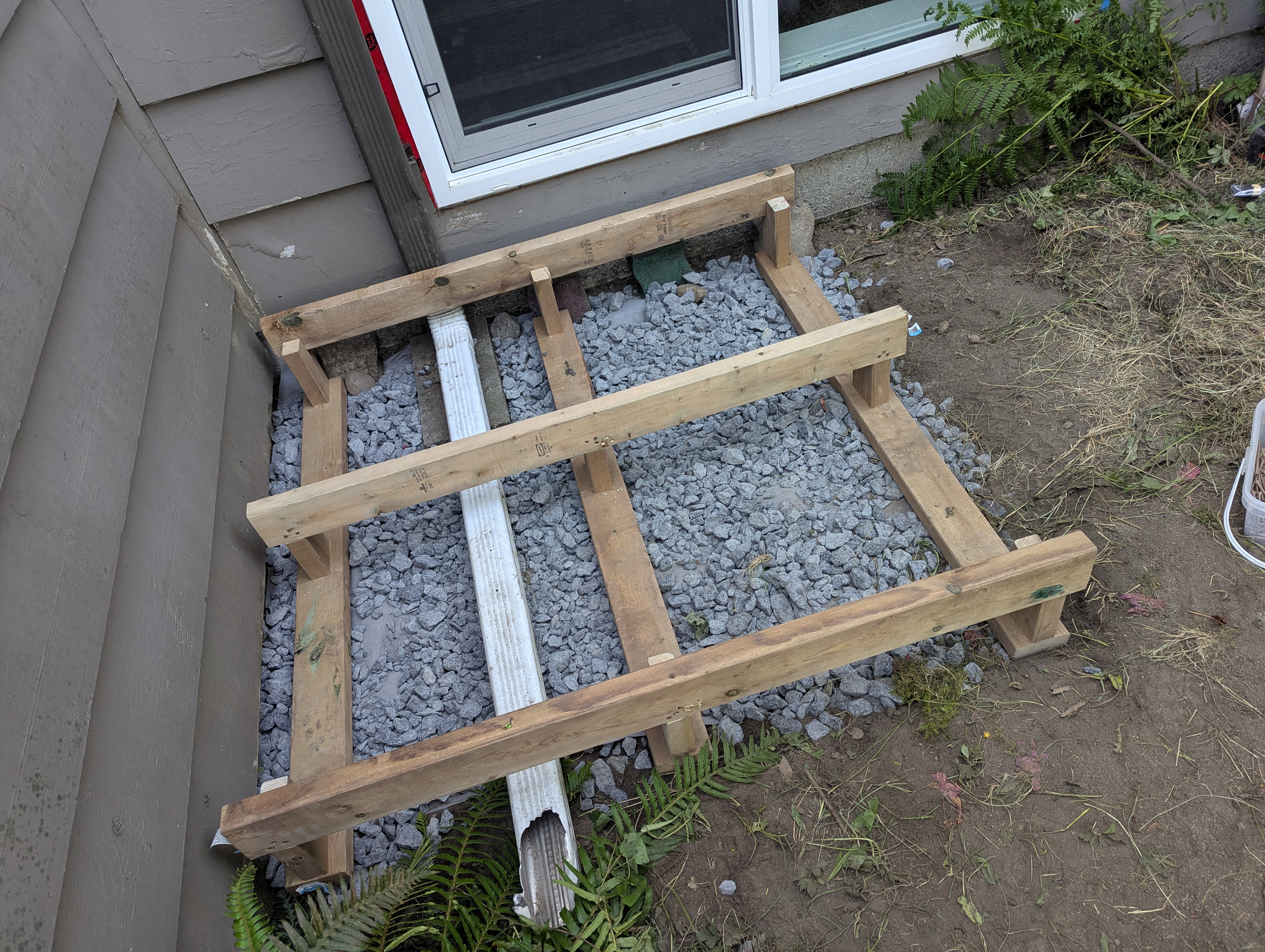 At first I thought I'd have to redirect the downspout but I brought a friend by for his two cents and he immediately said "platform"