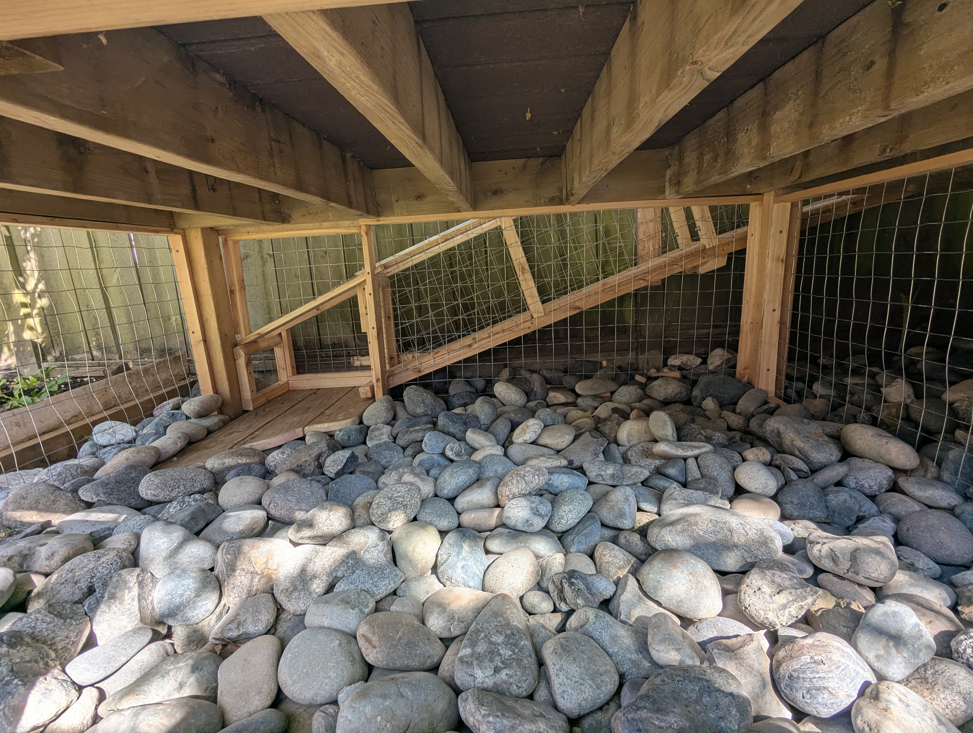 The ramp emerges into the space beneath the play structure.