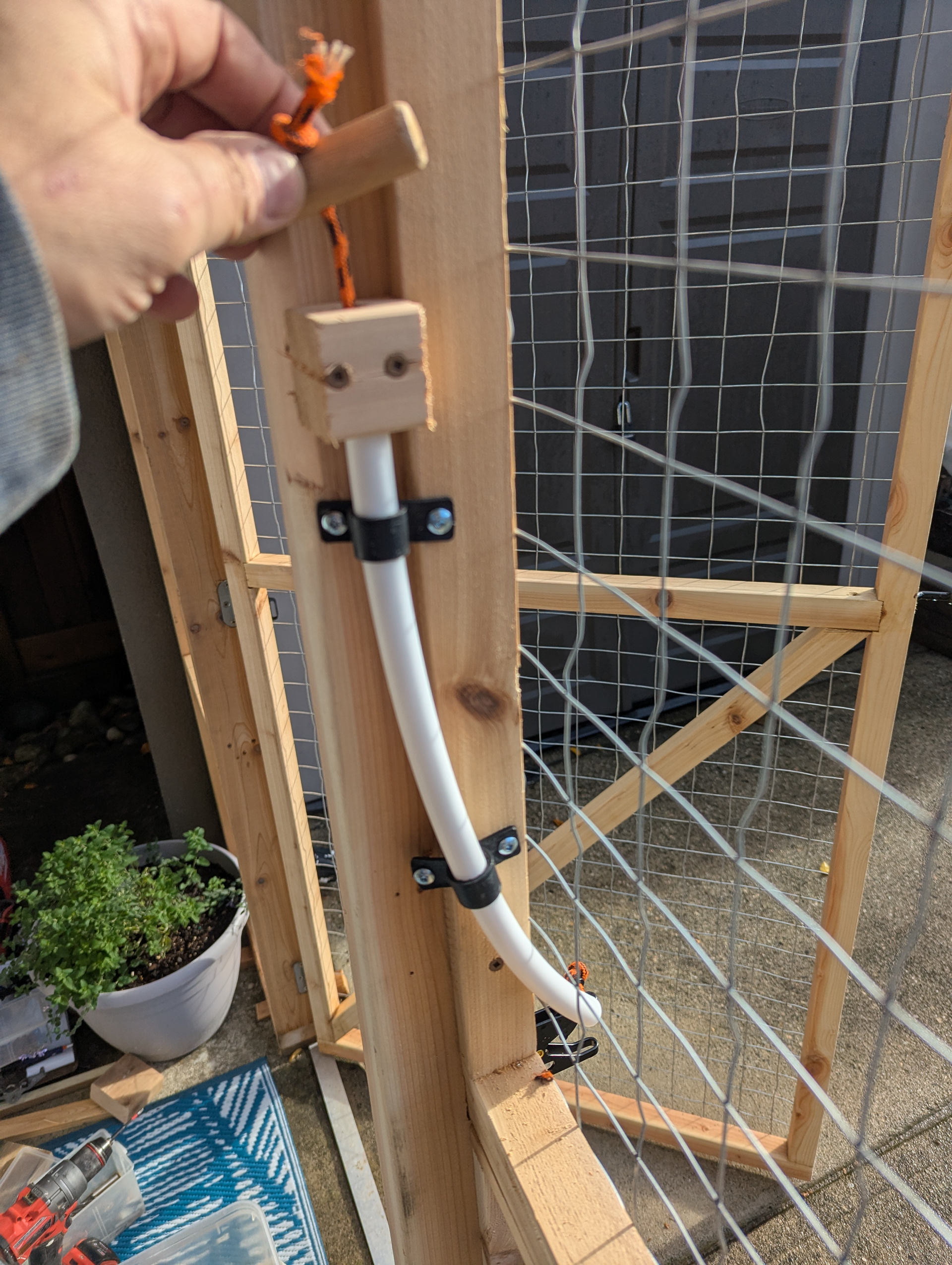 And a tube was added to reverse the pull on the latch, to thwart clever little paws. 