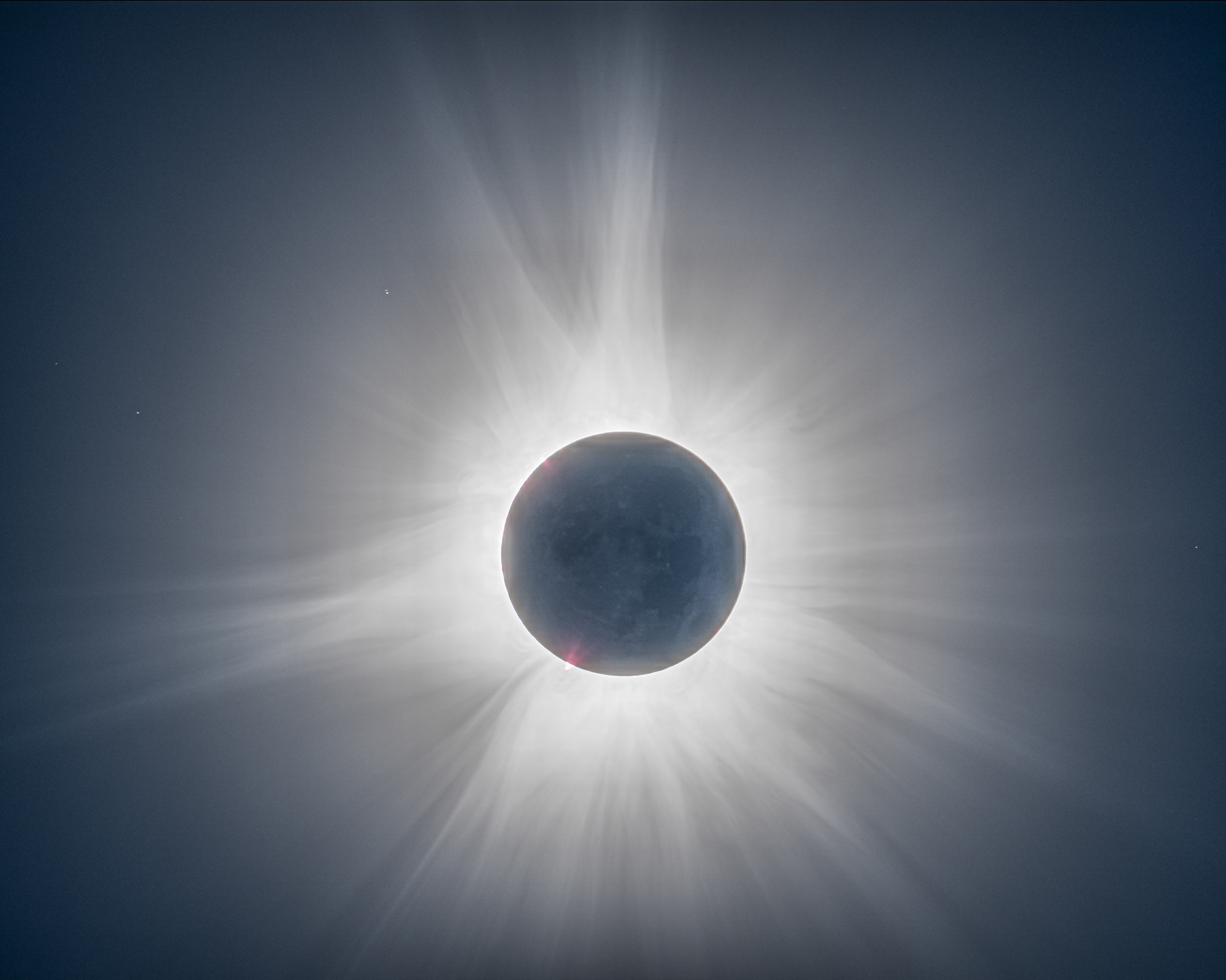 HDR image composed of 9 images taken with different exposure settings showing the corona, the surface of the moon and stars