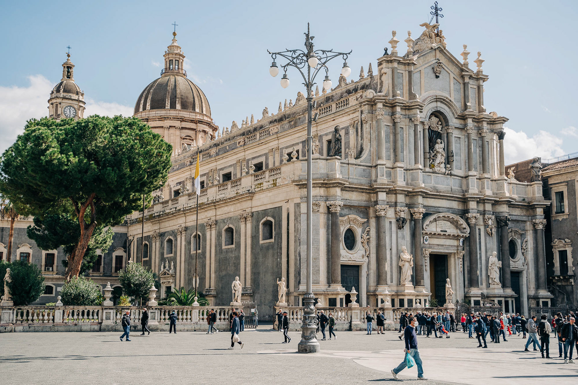 Catania's cathedral of Saint Agatha photographed during the day with several people walking in front of it