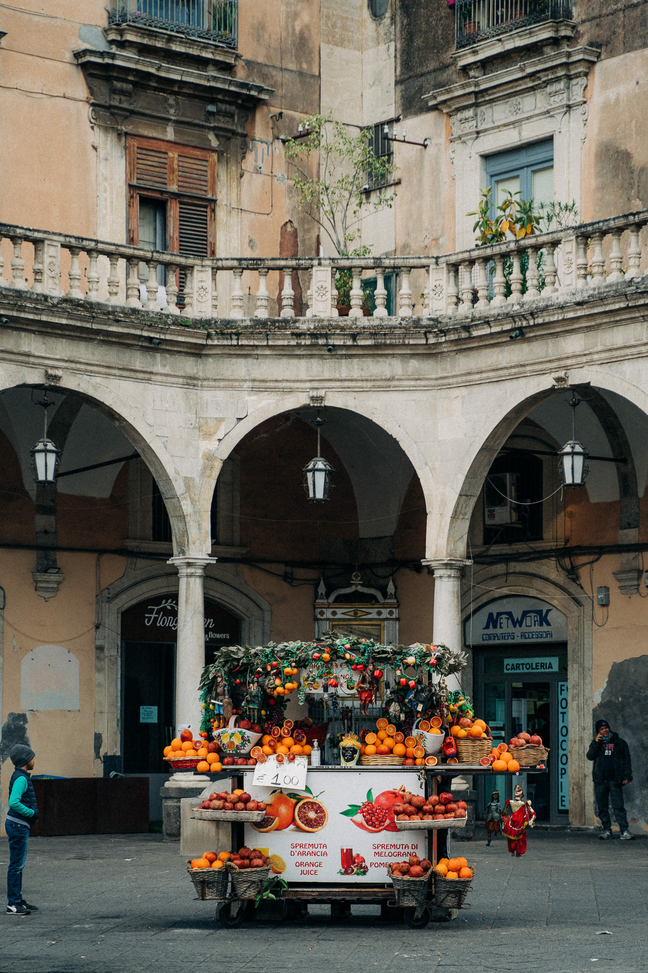 A fruit stall standing in front of an old Italian building