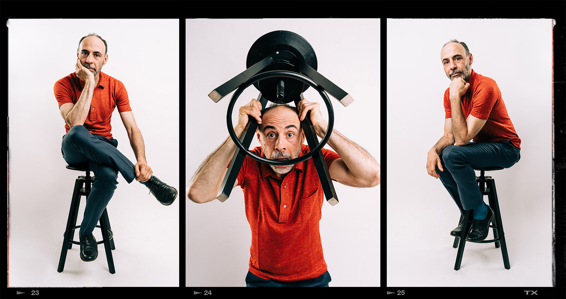 Florian Tröbinger photographed in a studio sitting on a stool