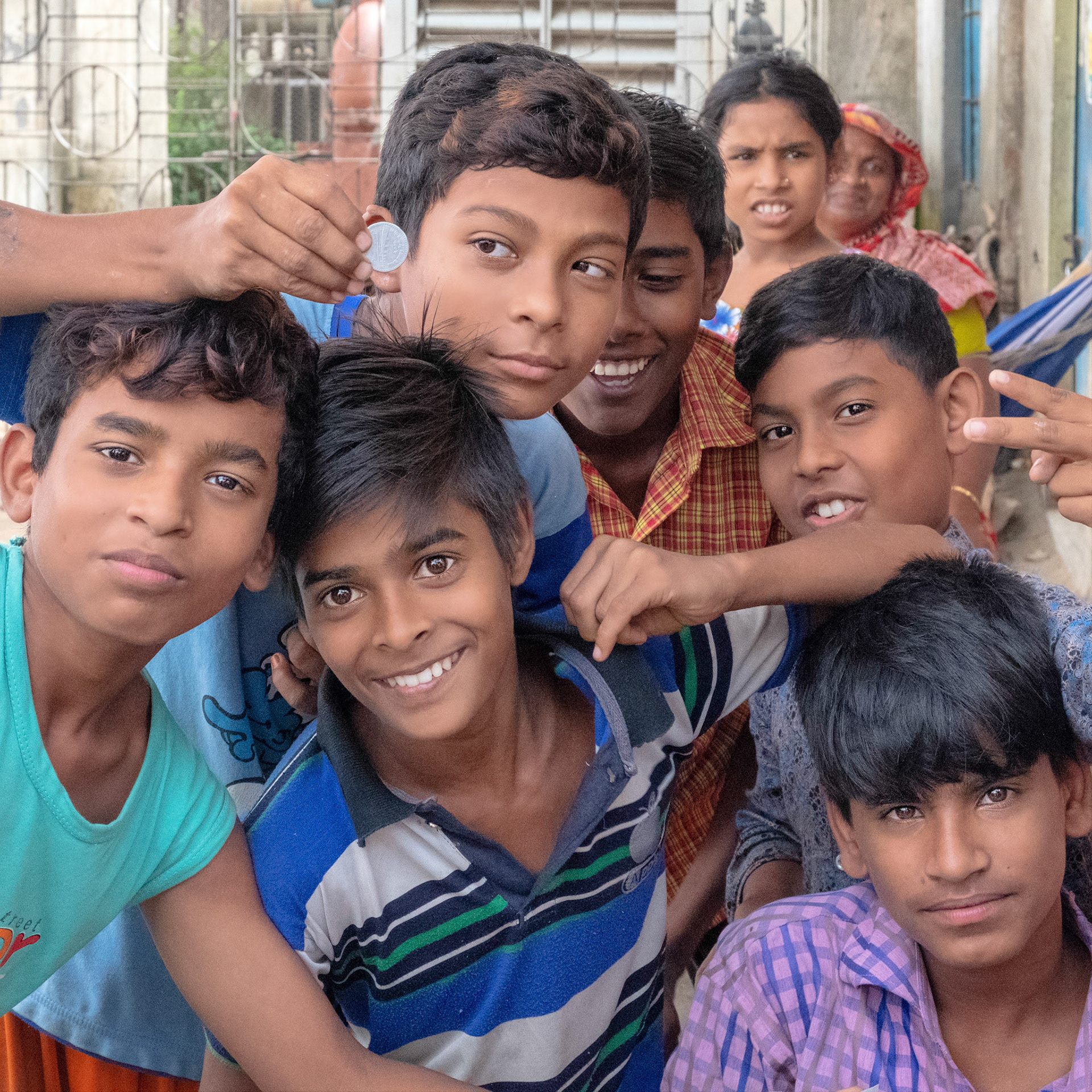 Children posing for a stranger with a camera